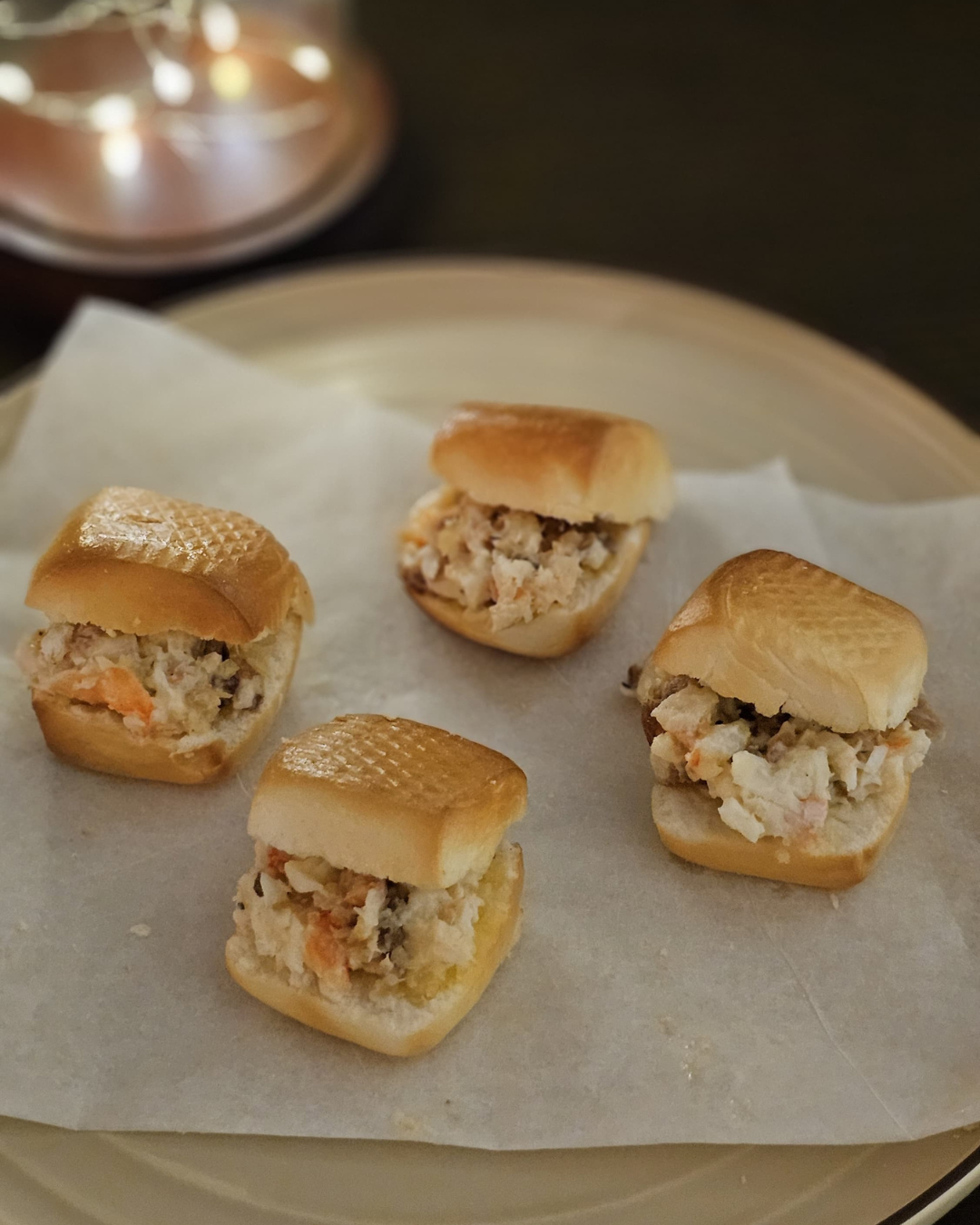 Our Cozy Area: 3 Ways Comfort Meets the Ground - Small, golden-brown buns filled with crab meat, placed on a parchment paper