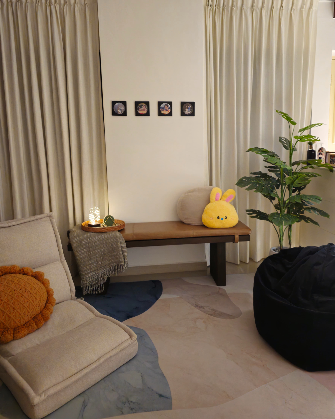 Our Cozy Area: 3 Ways Comfort Meets the Ground - Cream-colored sofa, plush orange pillow, beige armchair, wooden bench