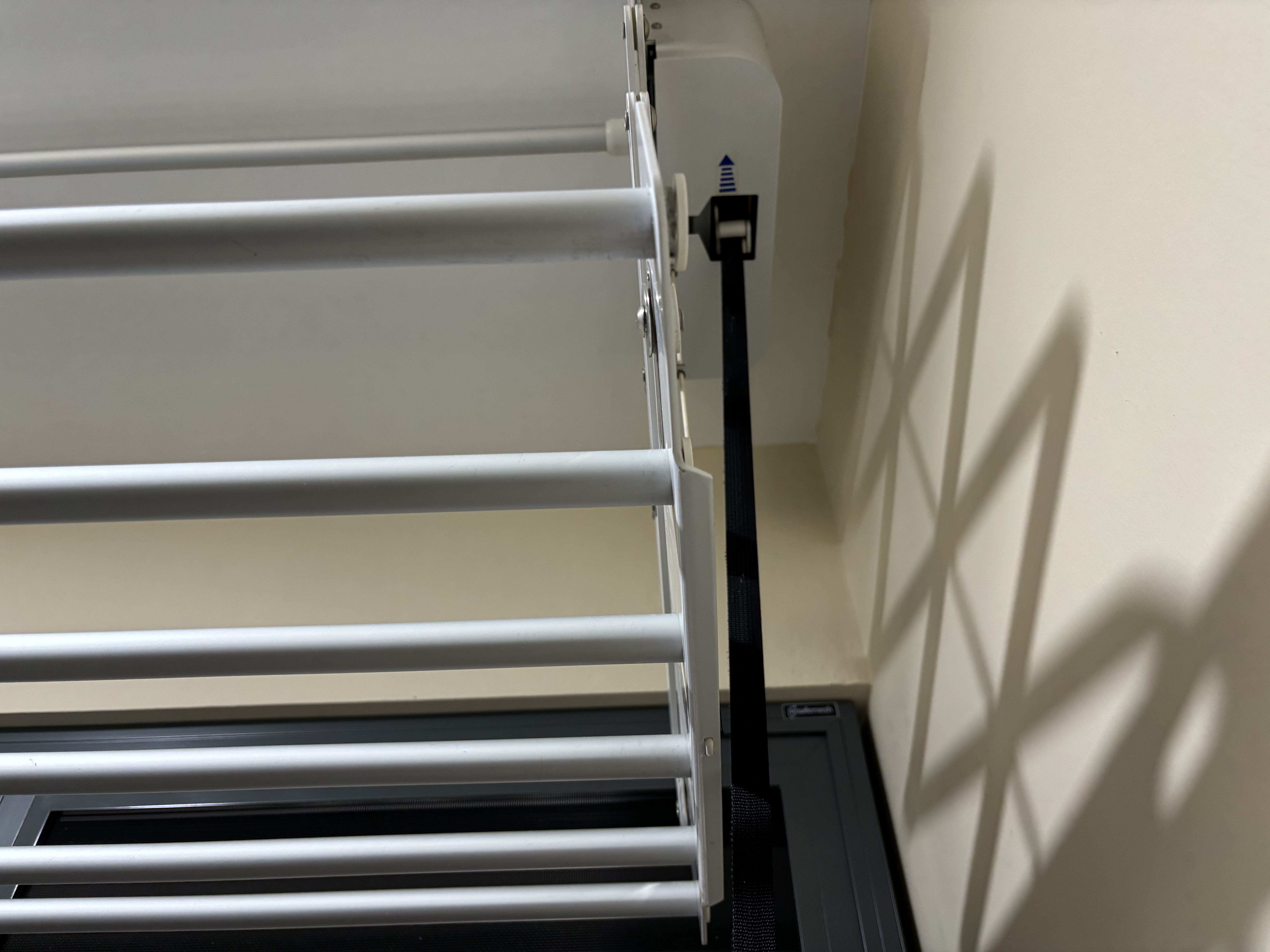 BTO Laundry Rack: To keep or not to keep? - White window blinds, black roller shades, beige wall, shadow cast by blinds