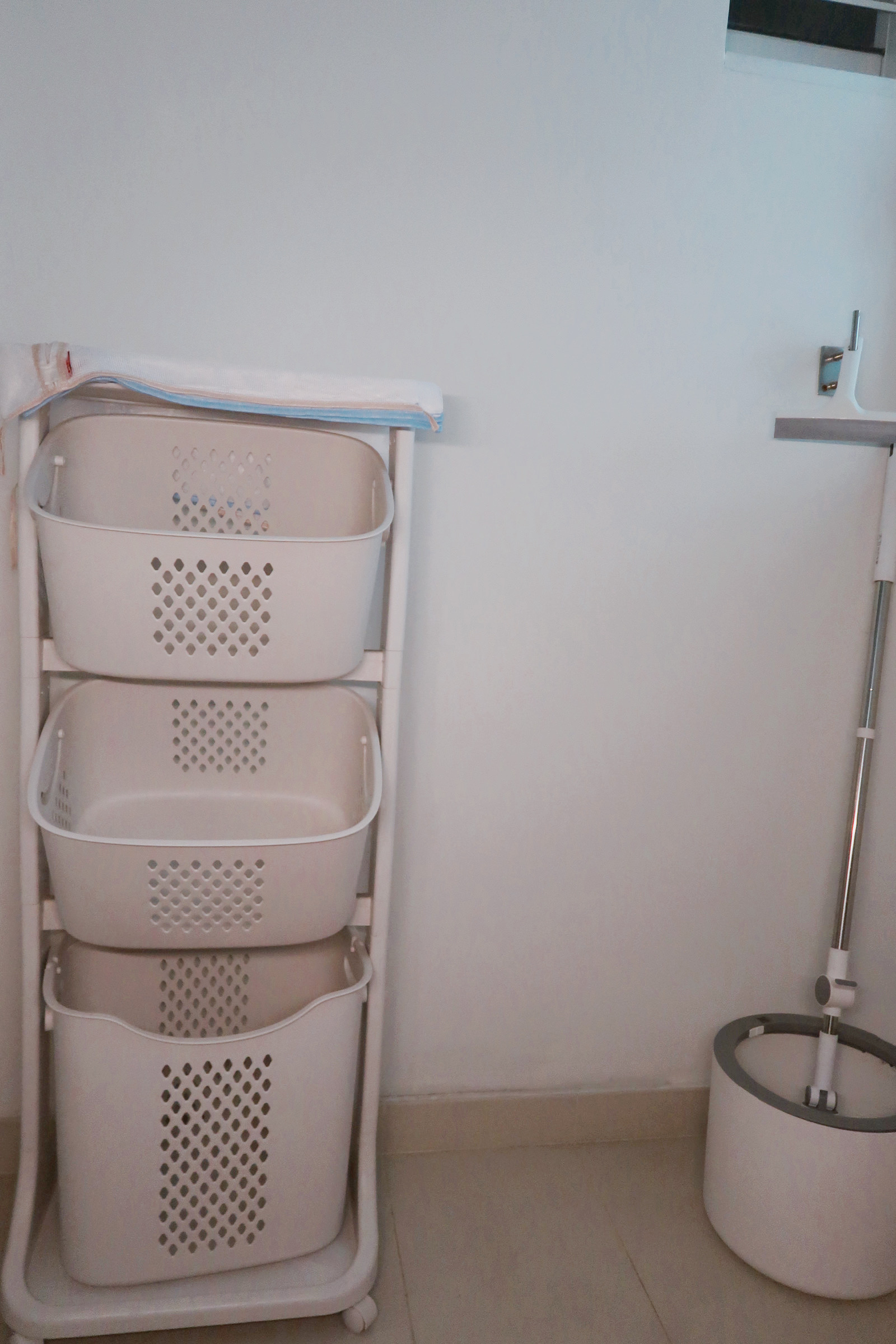 Our Service Yard: Ideas for Small Laundry Area 🧺 - White laundry basket rack, three-tiered, white baskets, perforated