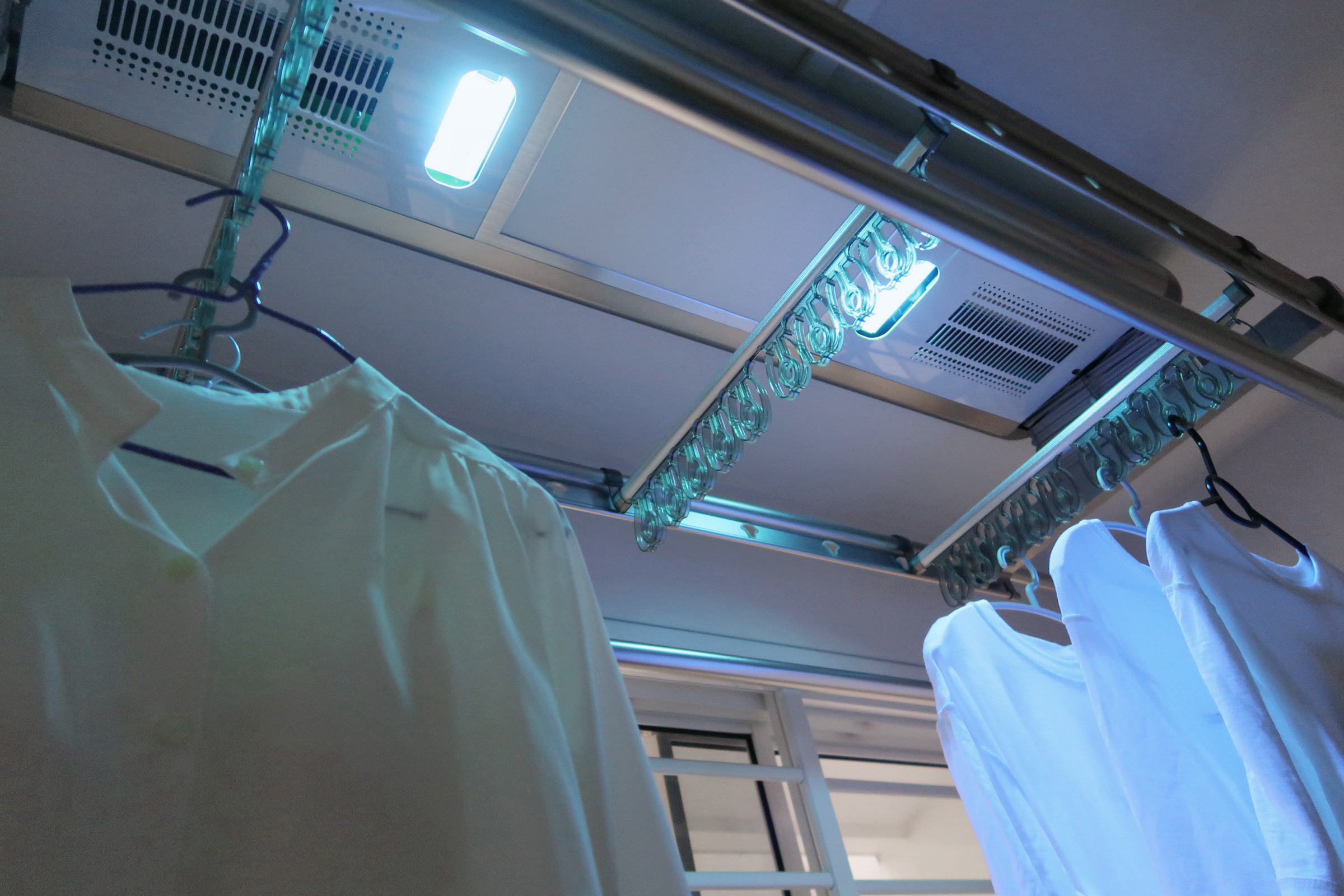 Our Service Yard: Ideas for Small Laundry Area 🧺 - White shirt, hanging, fluorescent light, metal rod, ceiling lights