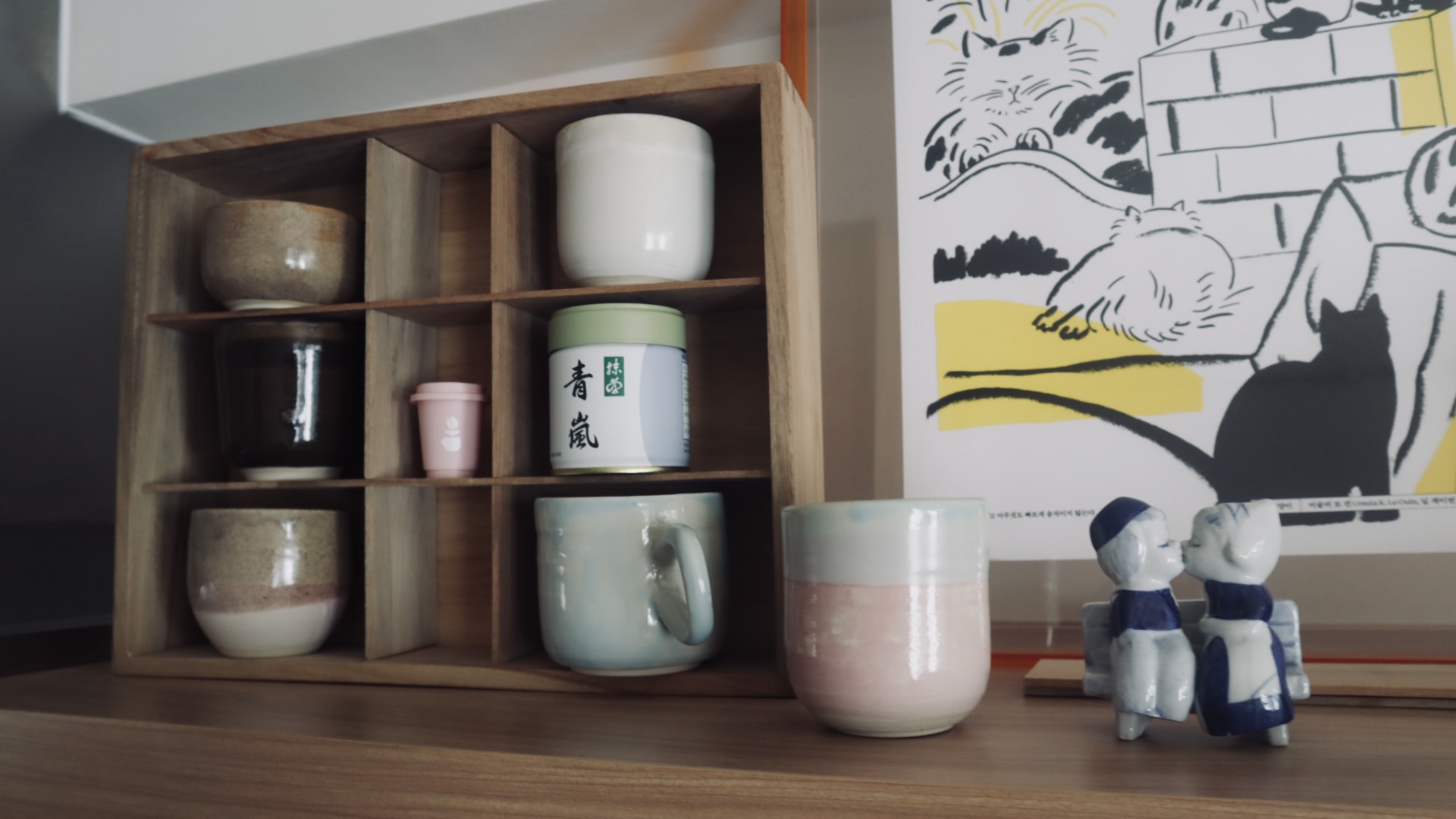 to each their own space - organisation for galley kitchen - Wooden tea cabinet with various ceramic items, including mugs and