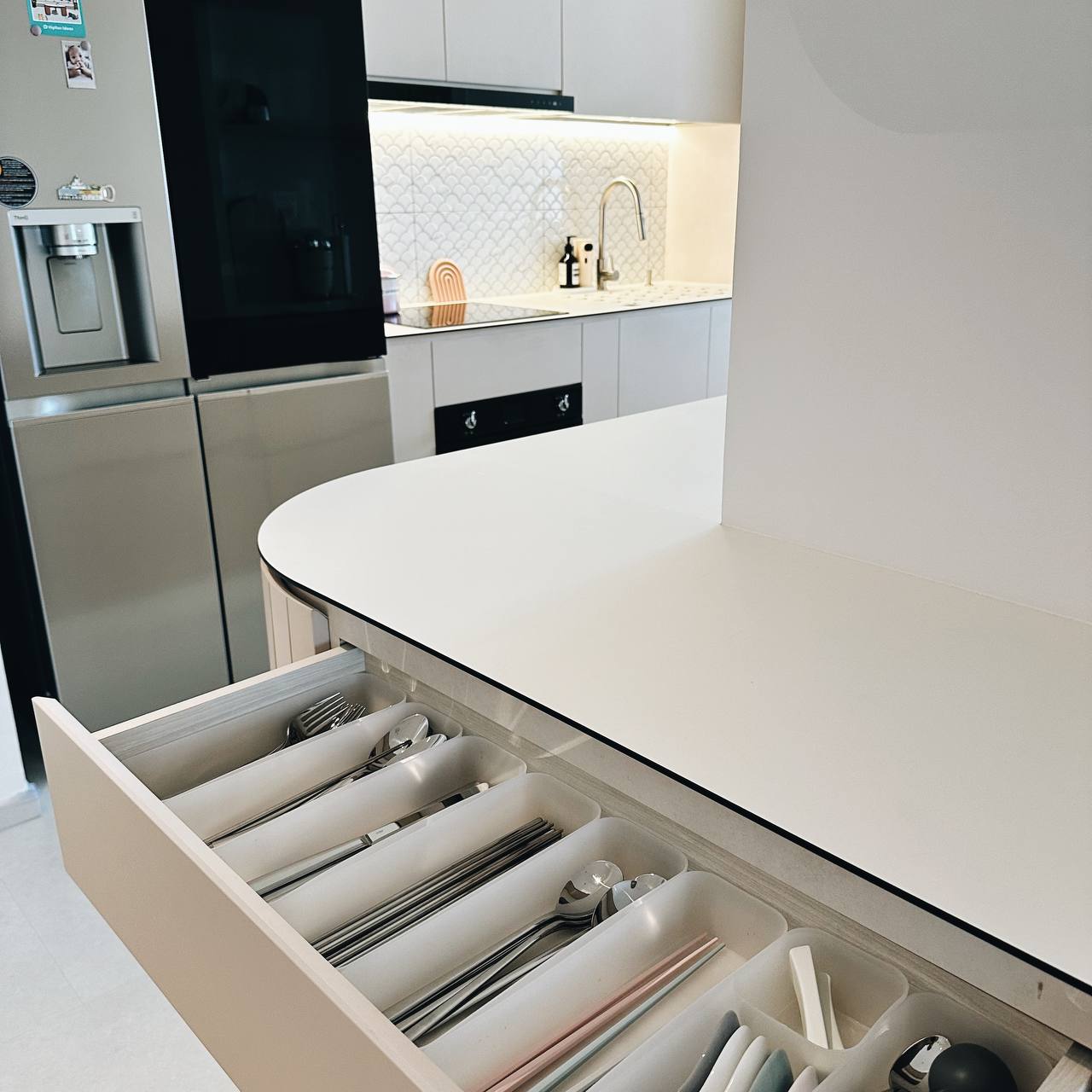 Our Kitchen Organization Tip: Hide the clutter!  - Modern kitchen, sleek design, open drawer, stainless steel refrigerator