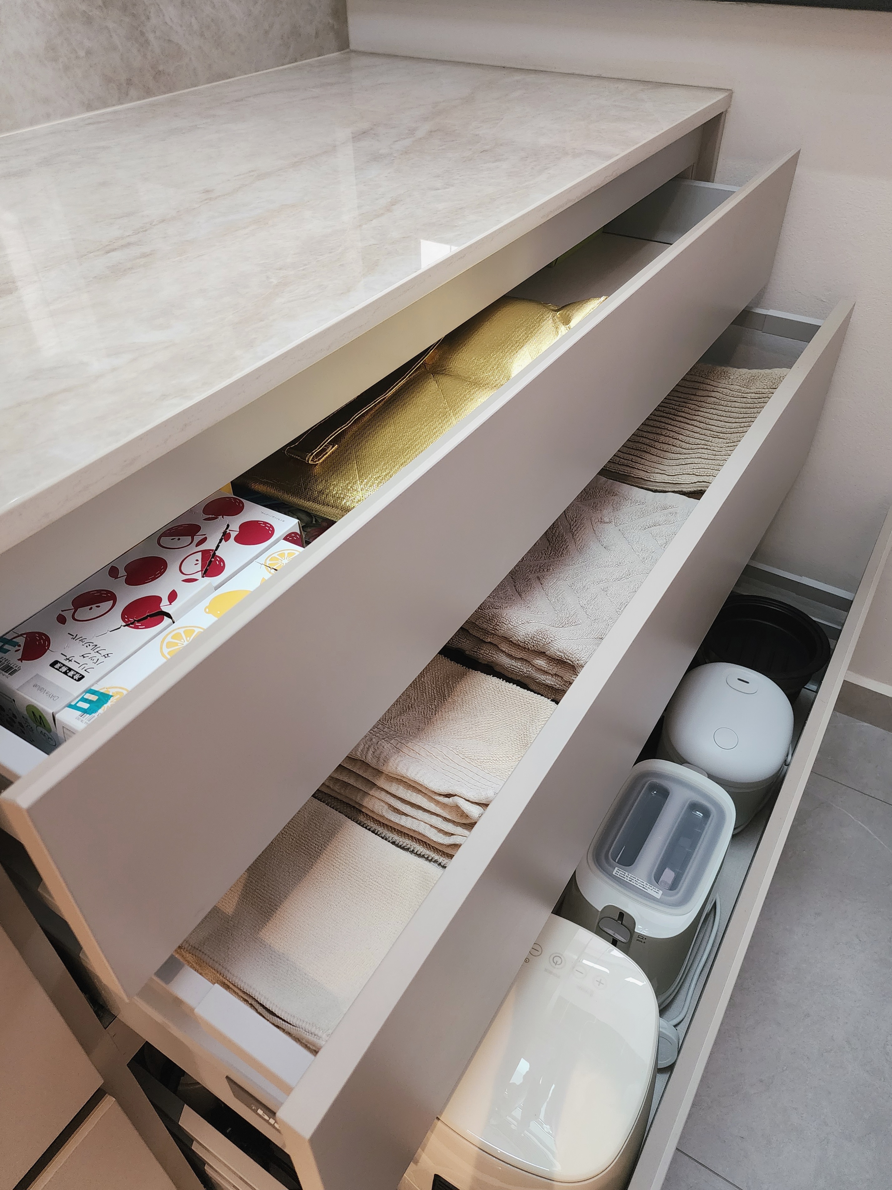 Our Kitchen Organisation: Peek Inside Our Cabinets & Drawers 👀 - White marble countertop, open drawer, neatly folded towels