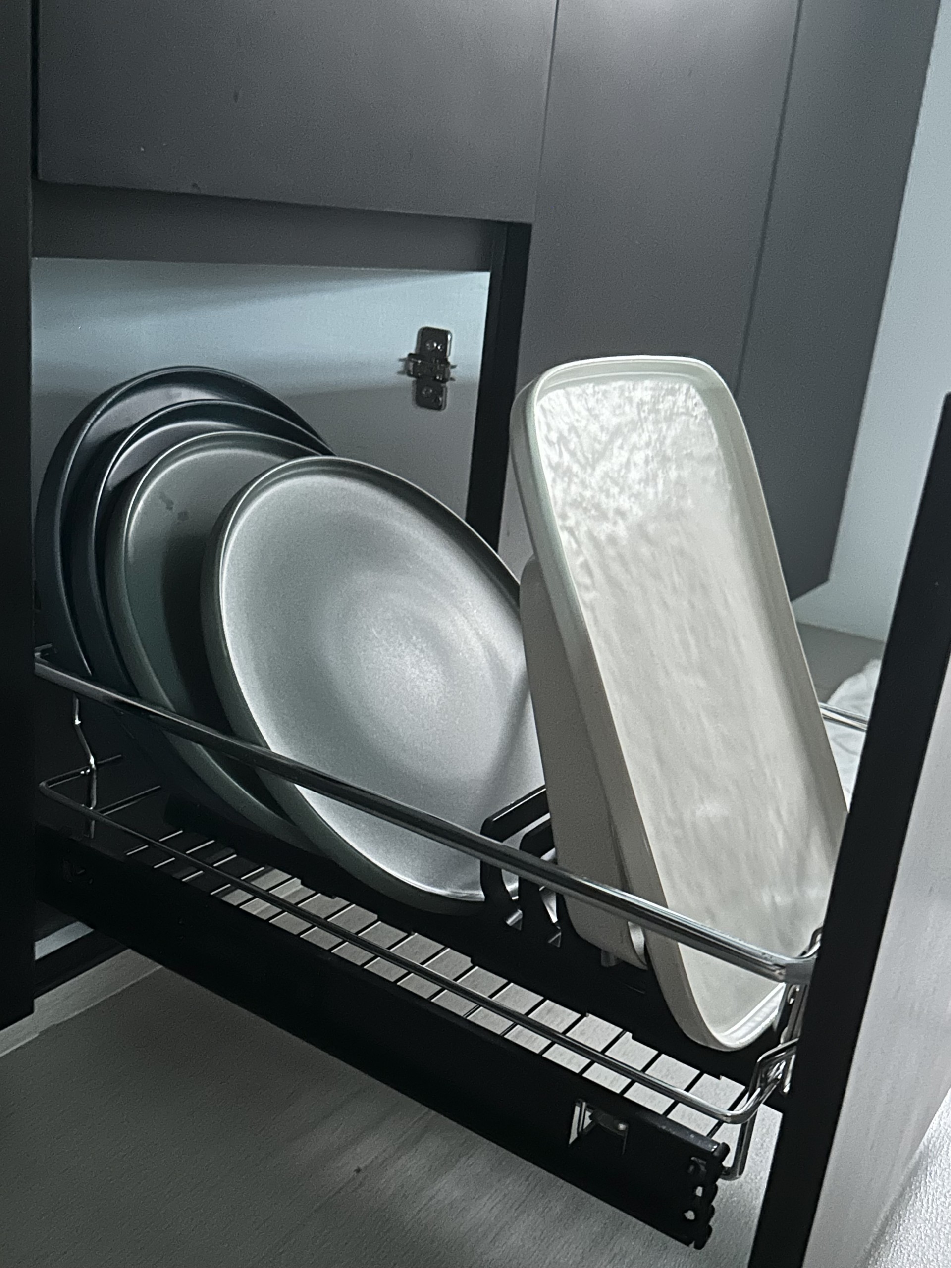 Kitchen Organisation: Streamlined Kitchen Essentials - Dish rack with stacked plates, sleek kitchen cabinet, modern storage