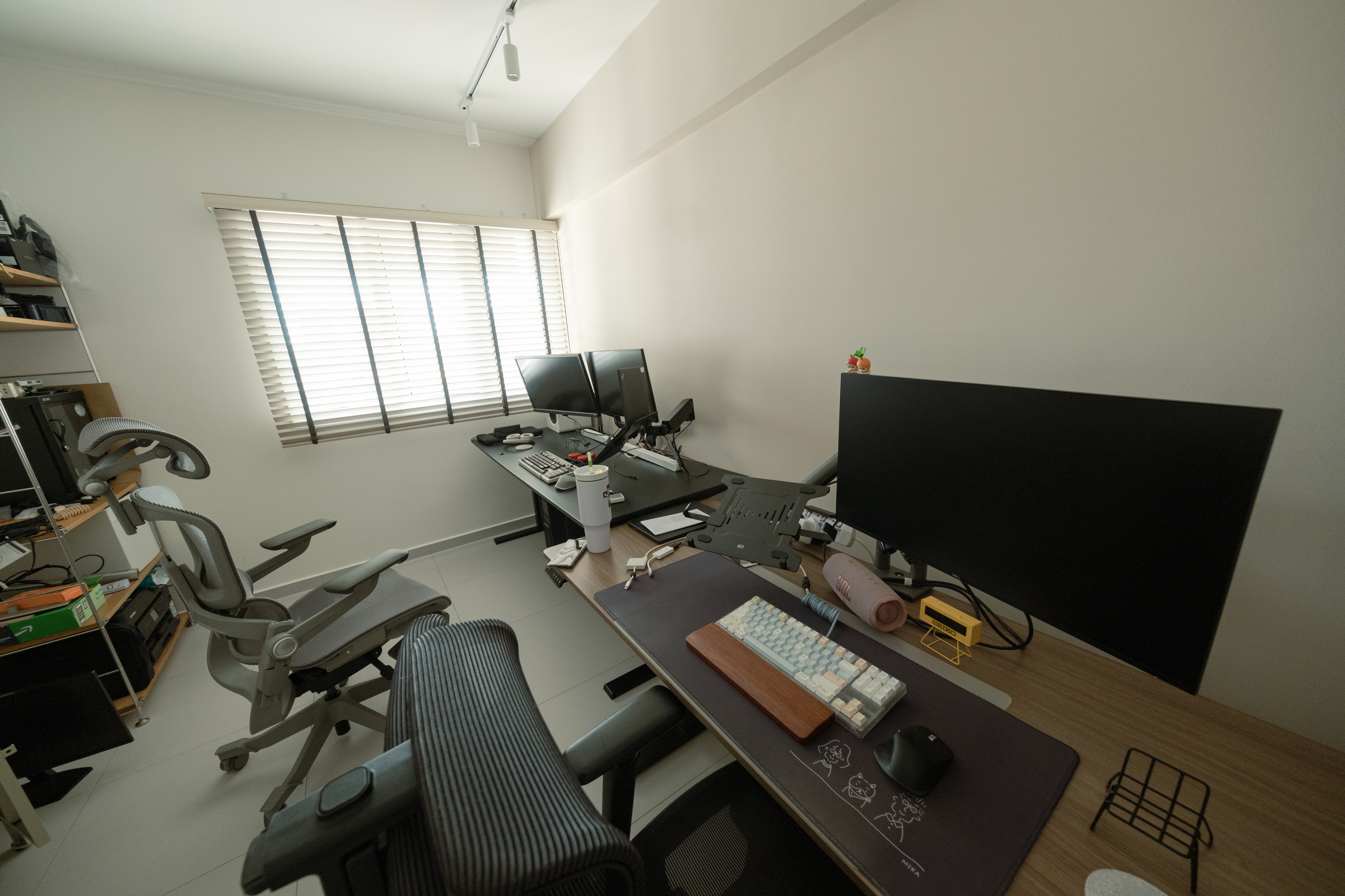 Maximising productivity in our study - Office desk with dual monitors, ergonomic chair, keyboard and mouse on mouse pad