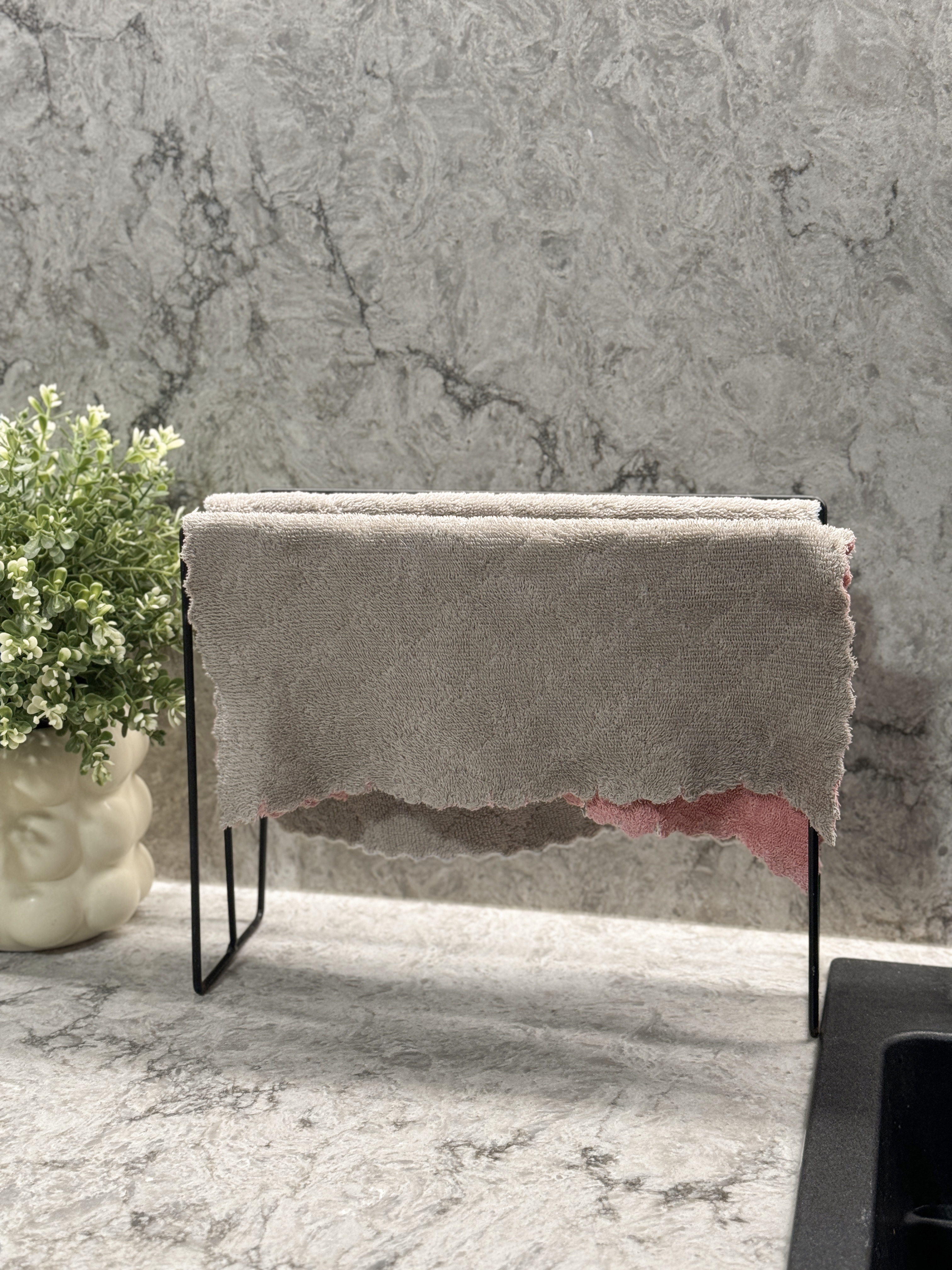 Cost Saving and Practical Tips for Organizing an Open Kitchen - Cream-colored, plush, textured towel, hanging on black metal