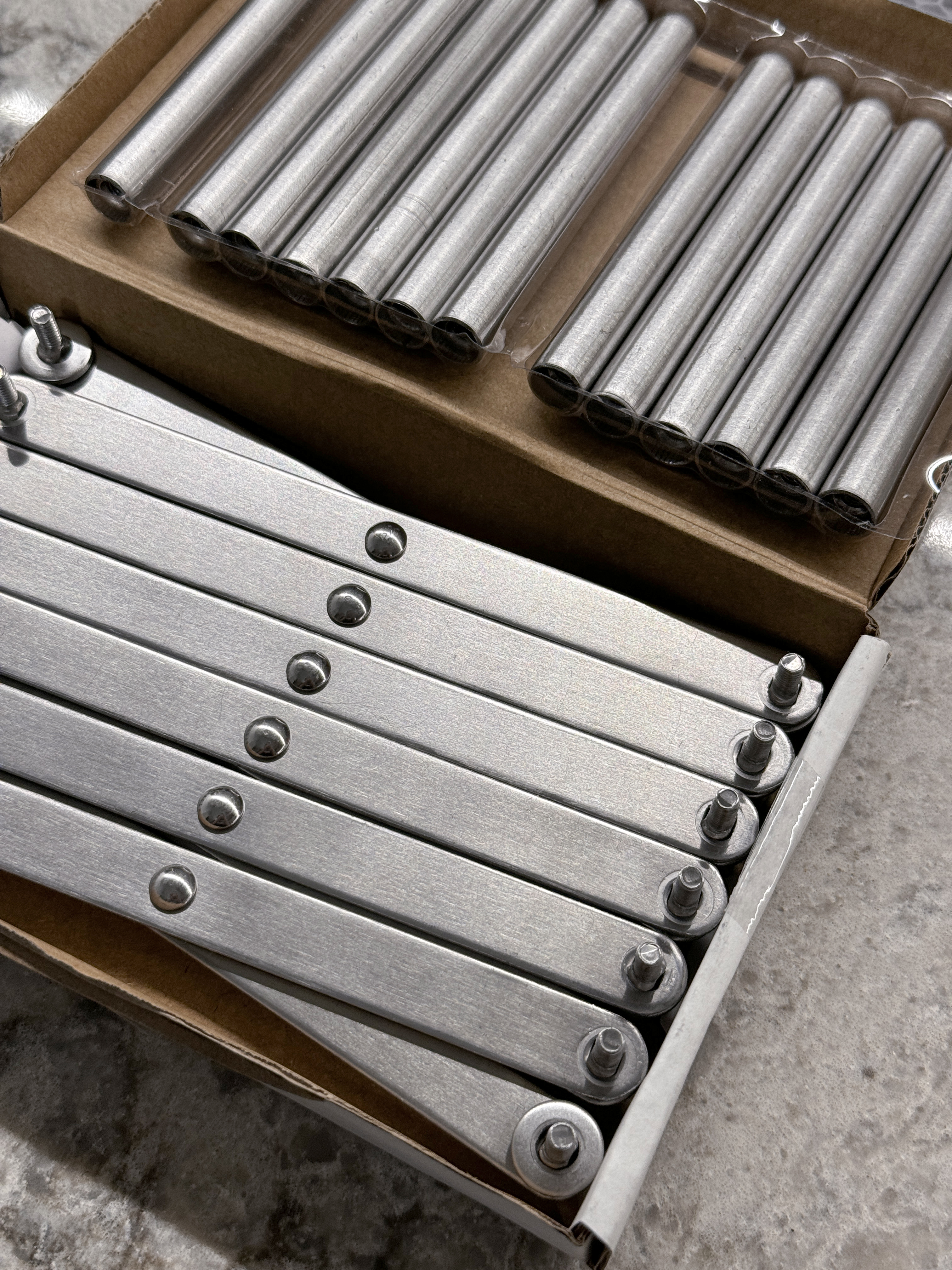 Cost Saving and Practical Tips for Organizing an Open Kitchen - metallic cylindrical components, metal rods, metal tubes