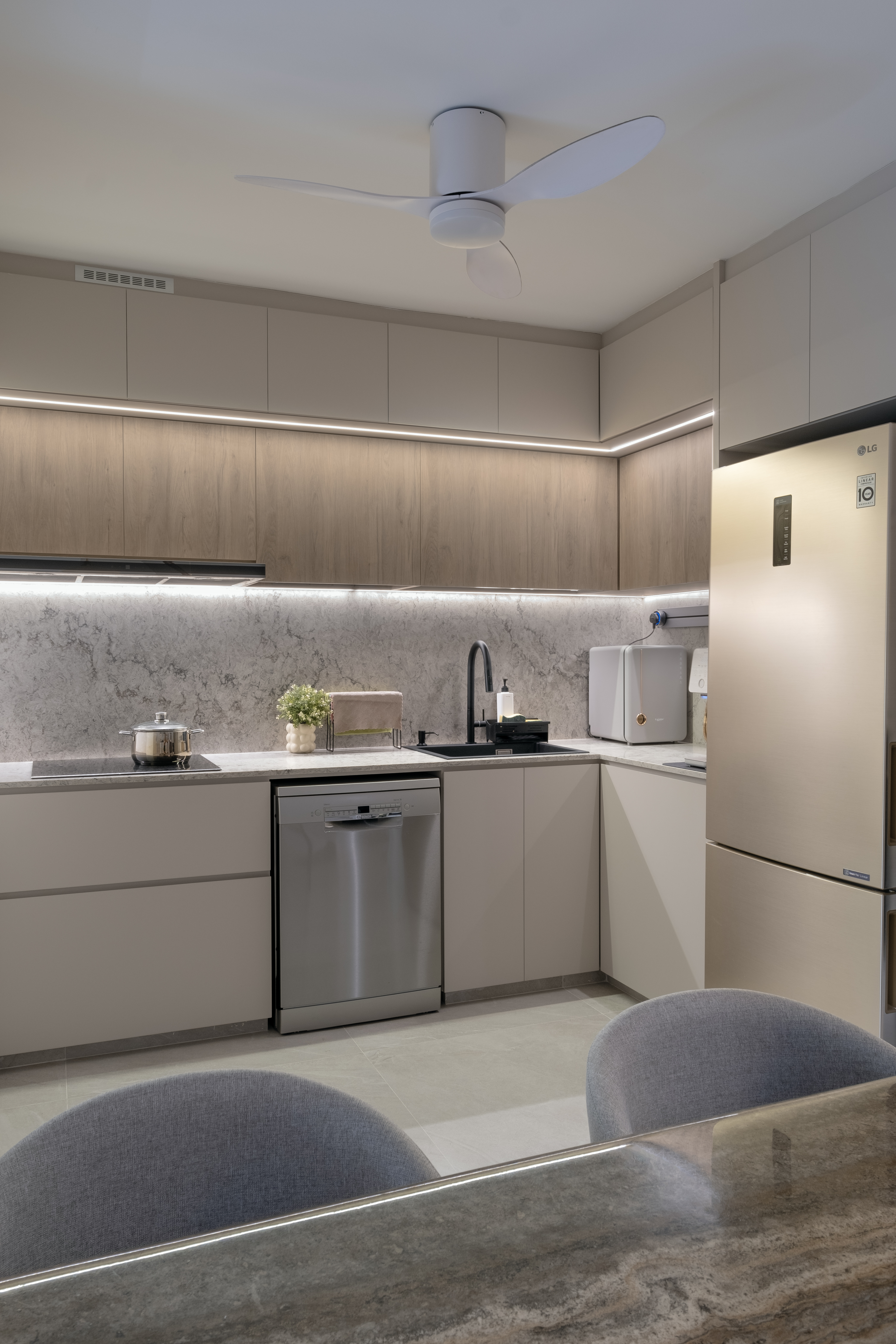 Cost Saving and Practical Tips for Organizing an Open Kitchen - Modern kitchen with sleek design, light wood cabinets, marble