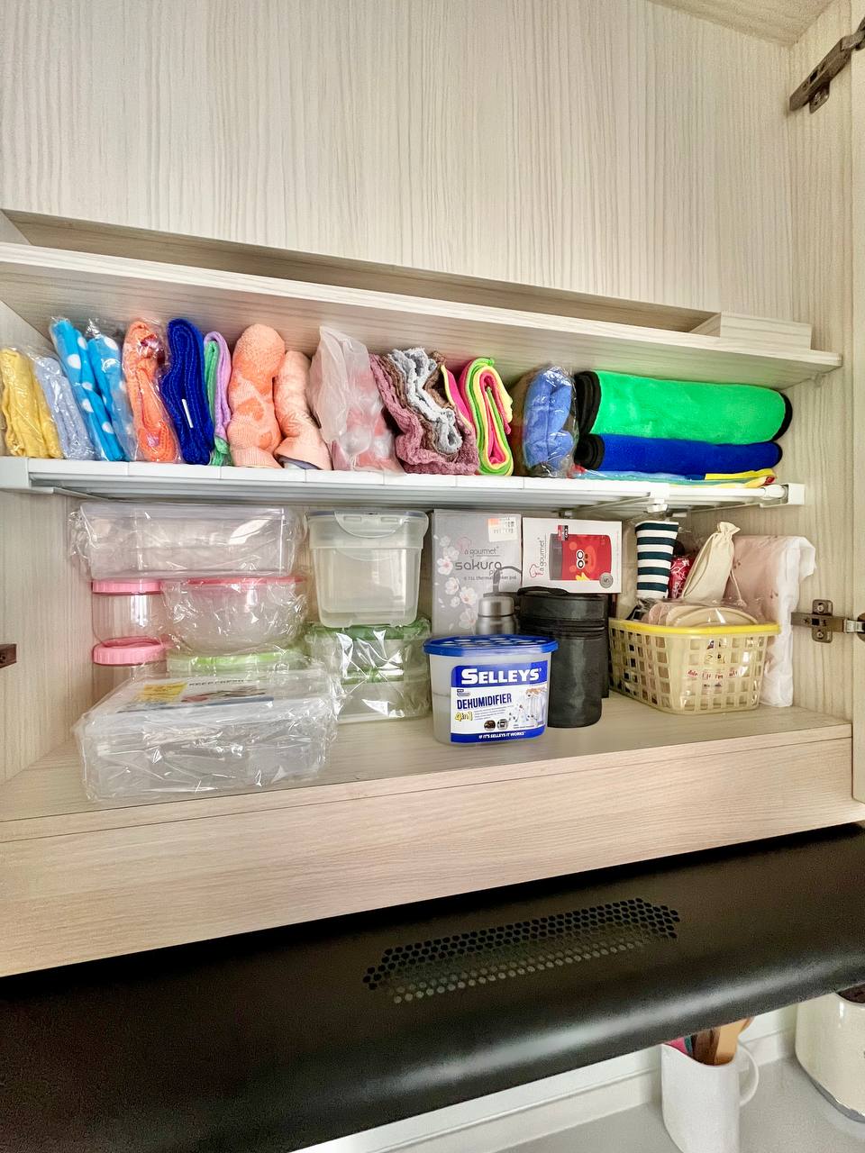 Kitchen Organisation and Reno Regret - Organized storage, neatly arranged items, colorful towels, soft toys, cleaning