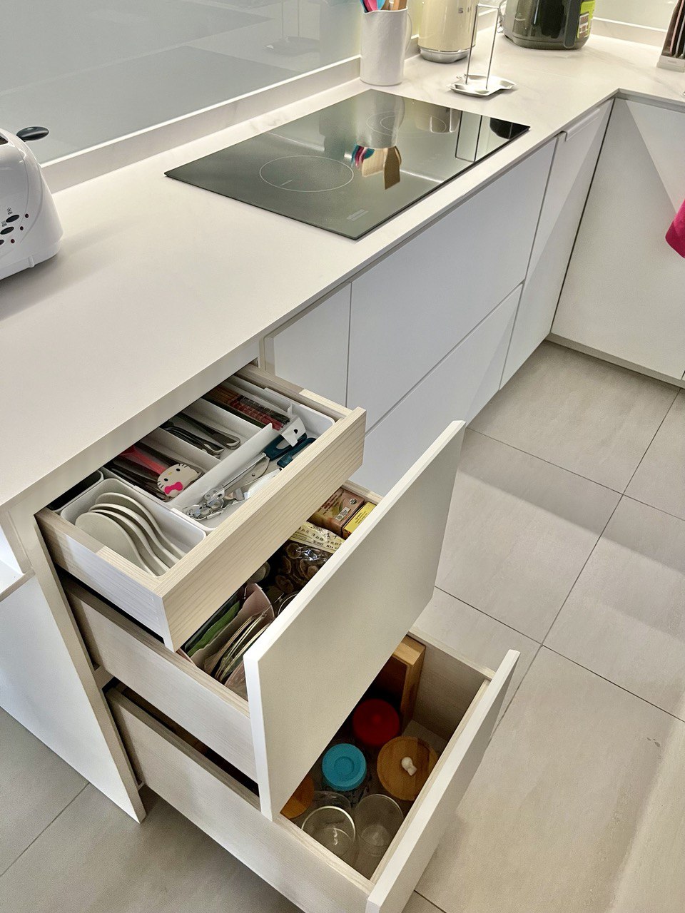 Kitchen Organisation and Reno Regret - White kitchen countertop, modern kitchen island, open drawer, neatly organized