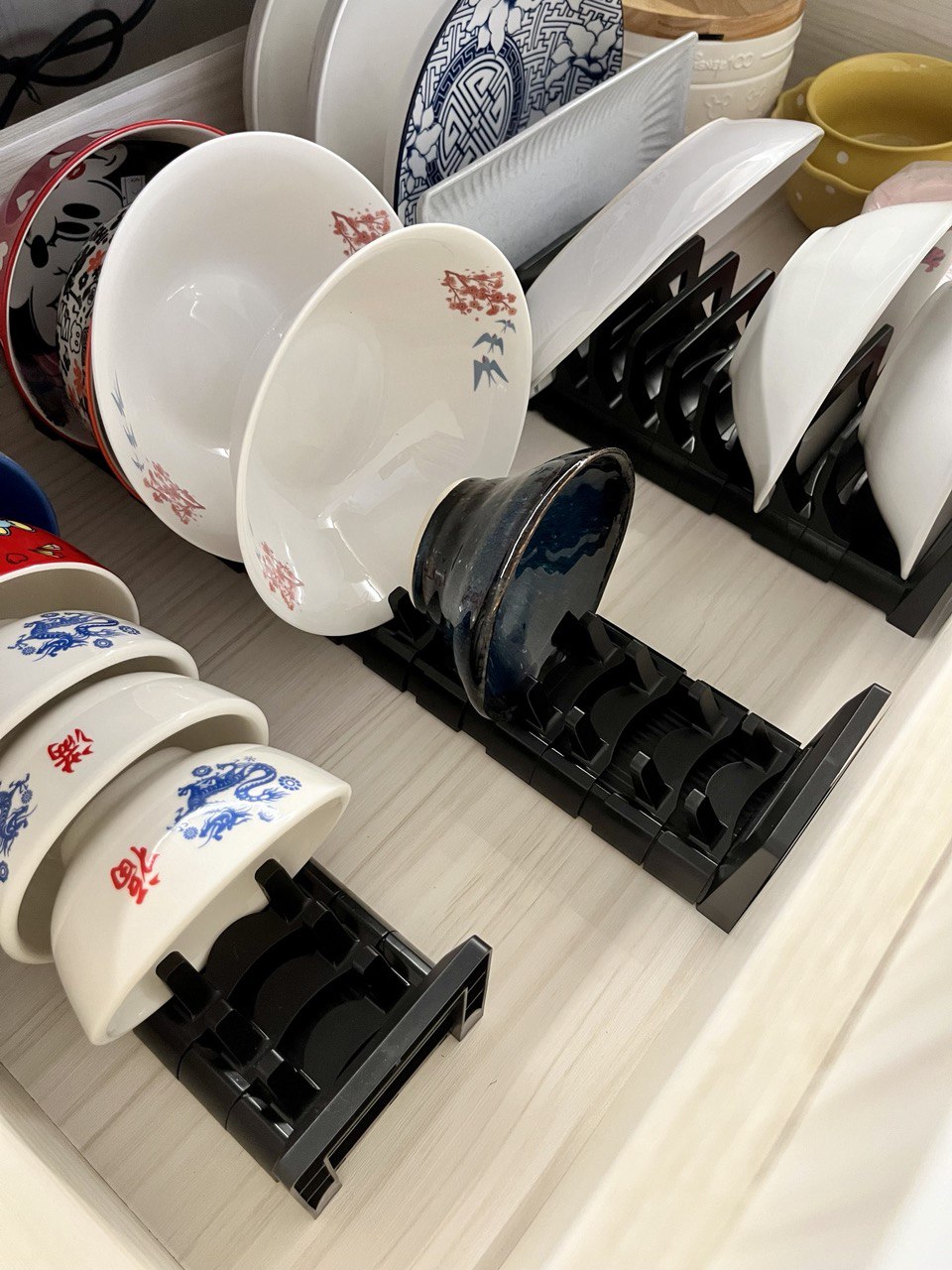 Kitchen Organisation and Reno Regret - White ceramic bowls with red and blue dragon designs, black and white patterned