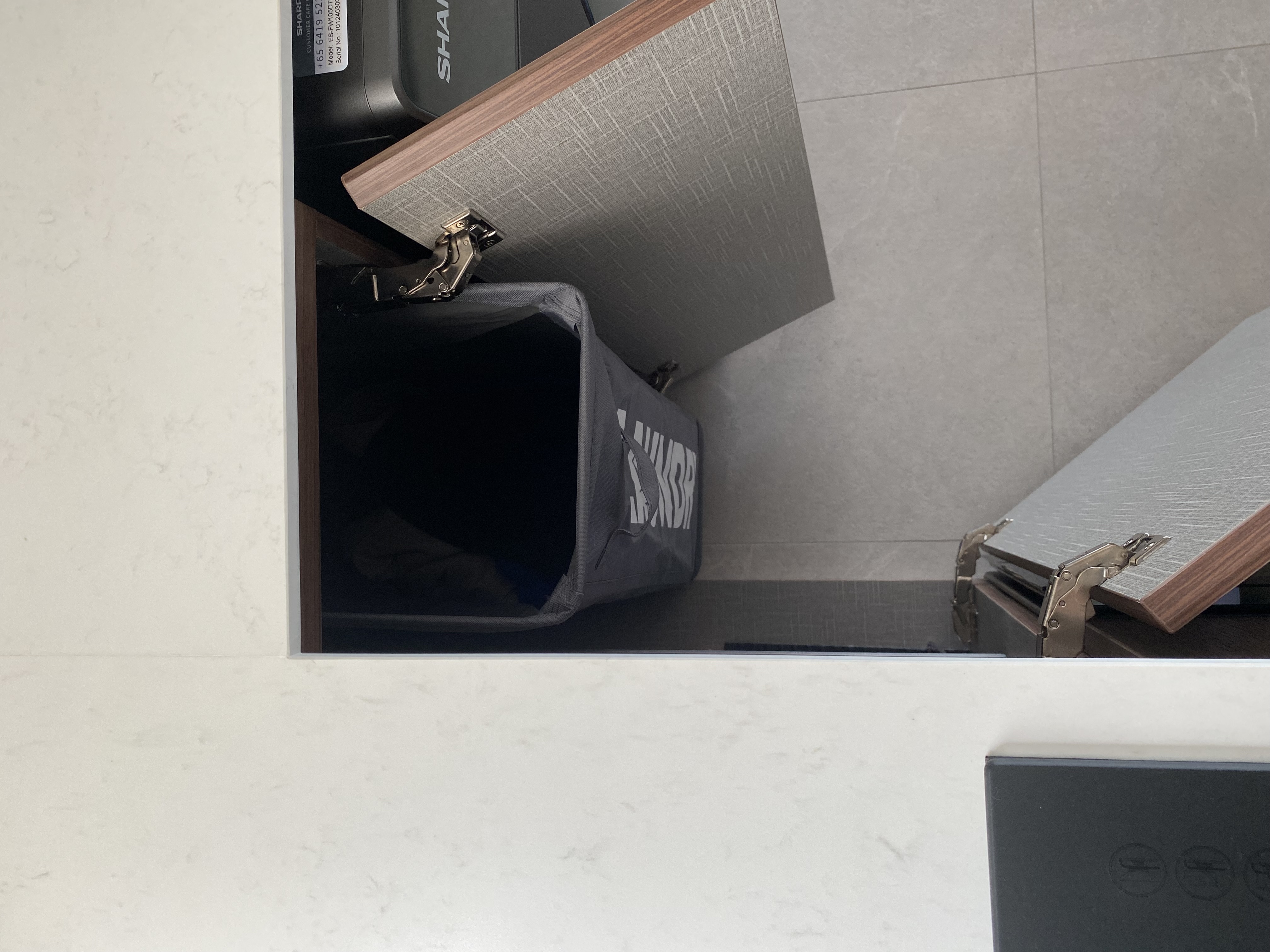 Stuff we keep in our small kitchen and how we did it ✨ - Interior storage compartment with a black trash bin labeled "SHARK"