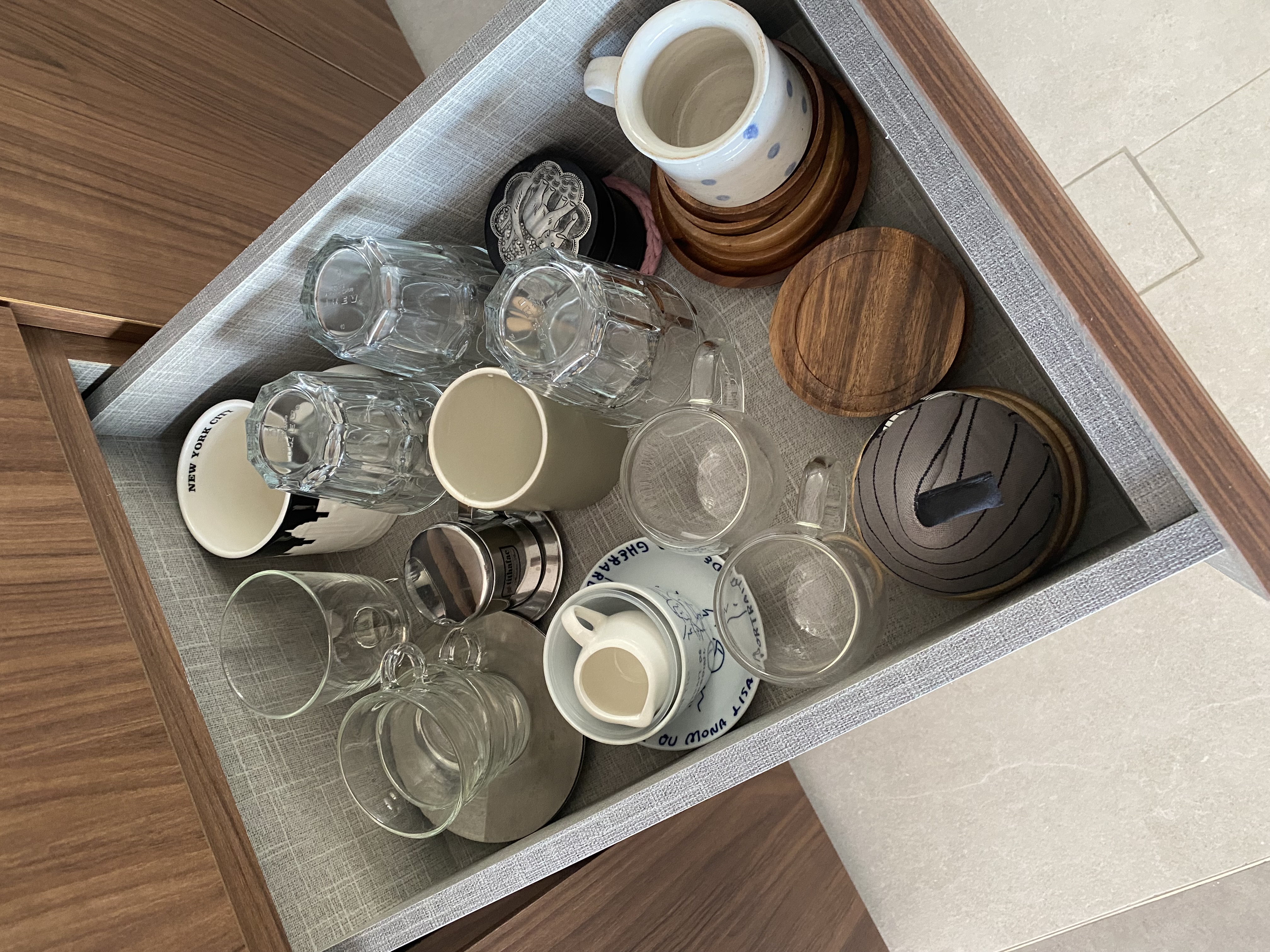 Stuff we keep in our small kitchen and how we did it ✨ - Clear glass cups, white ceramic pitcher, wooden coaster, metal