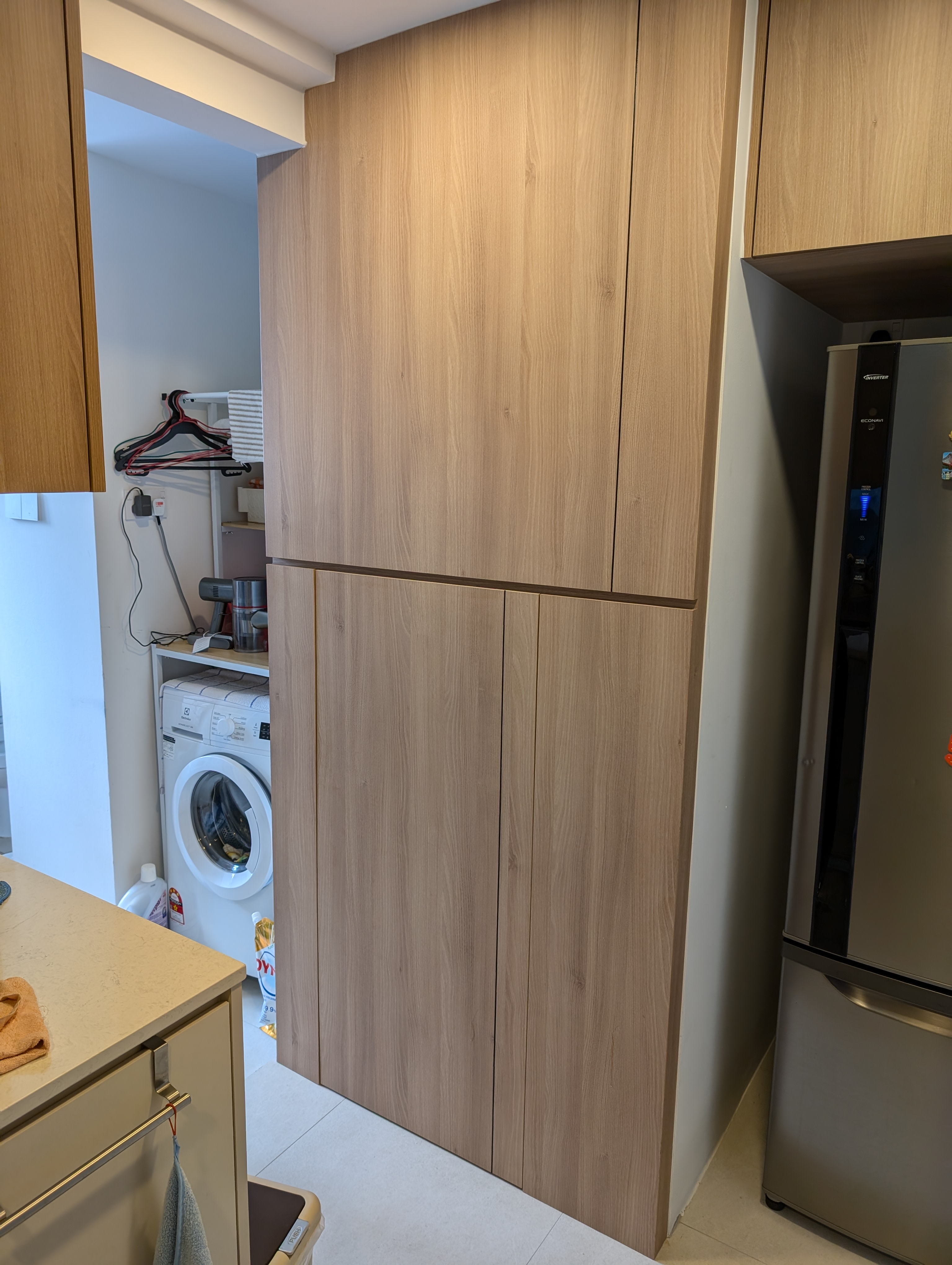 Our most unaesthetic post ever 😆 - Wooden kitchen cabinets, modern appliances, laundry area, white washing machine, wooden