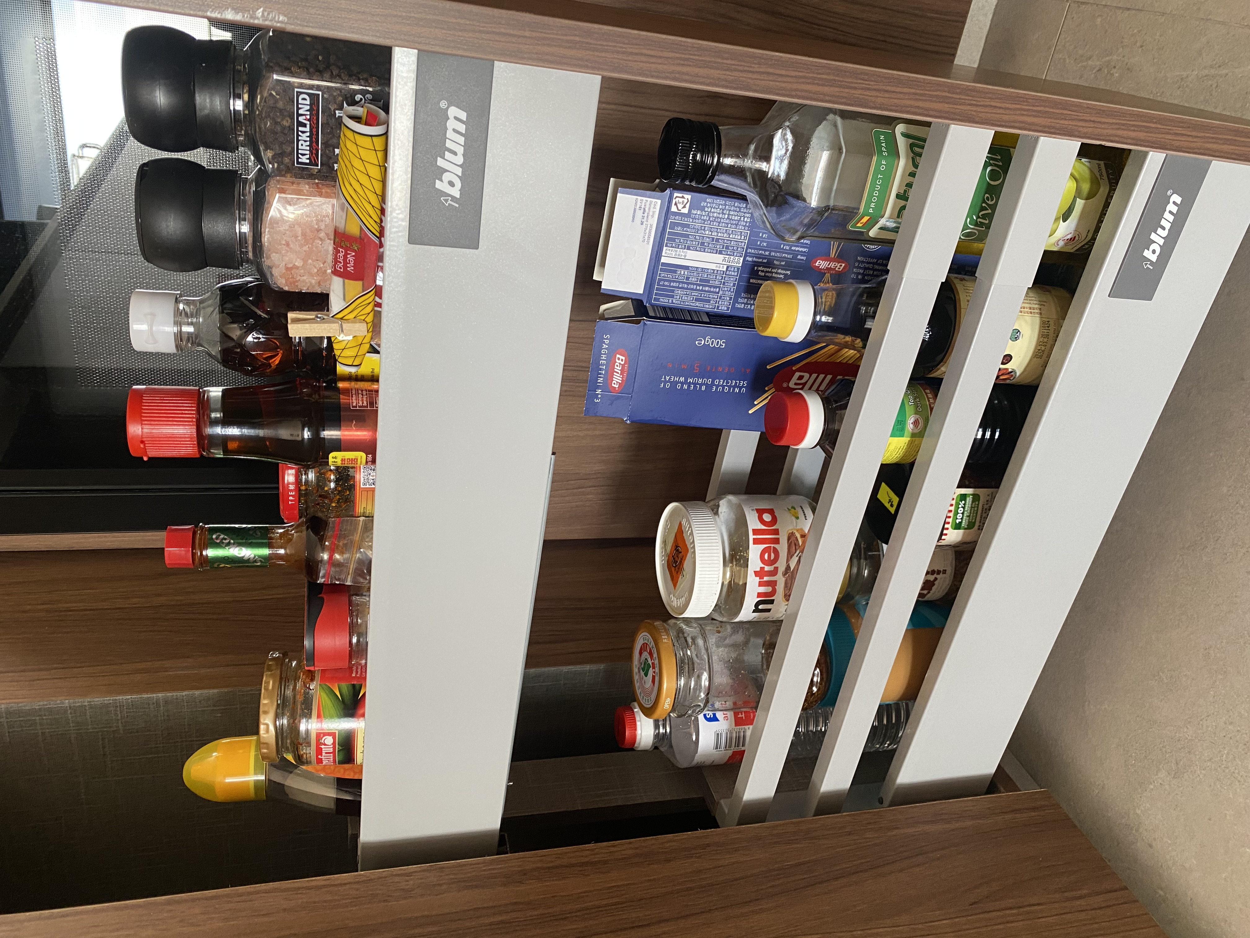 Stuff we keep in our small kitchen and how we did it ✨ - Shelf stocked with various bottles, including spices, oils, and