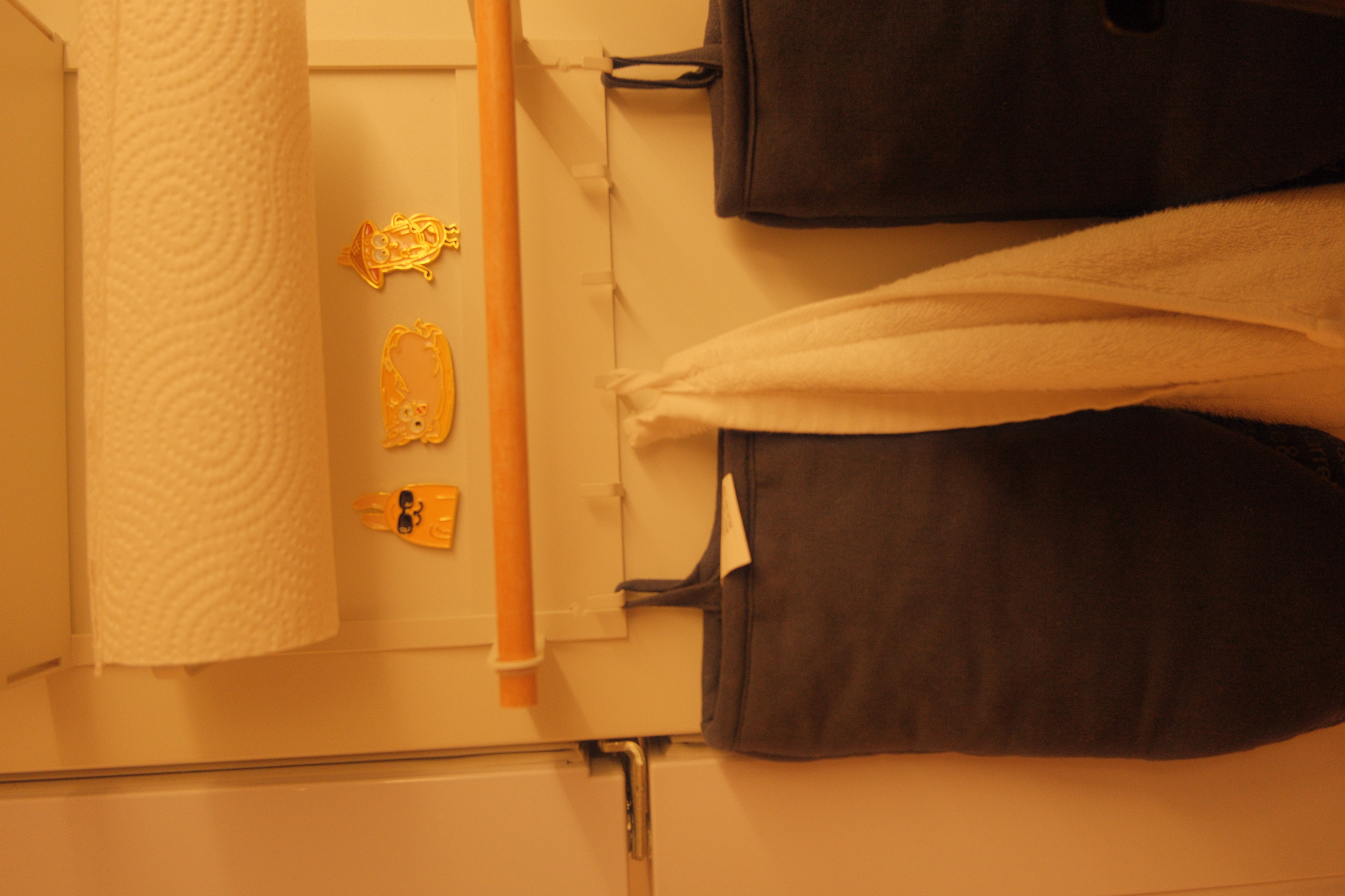 Check out how I Marie Kondo-ed my Kitchen  - Toilet paper roll, towel, folded towels, dark-colored bag, decorative items