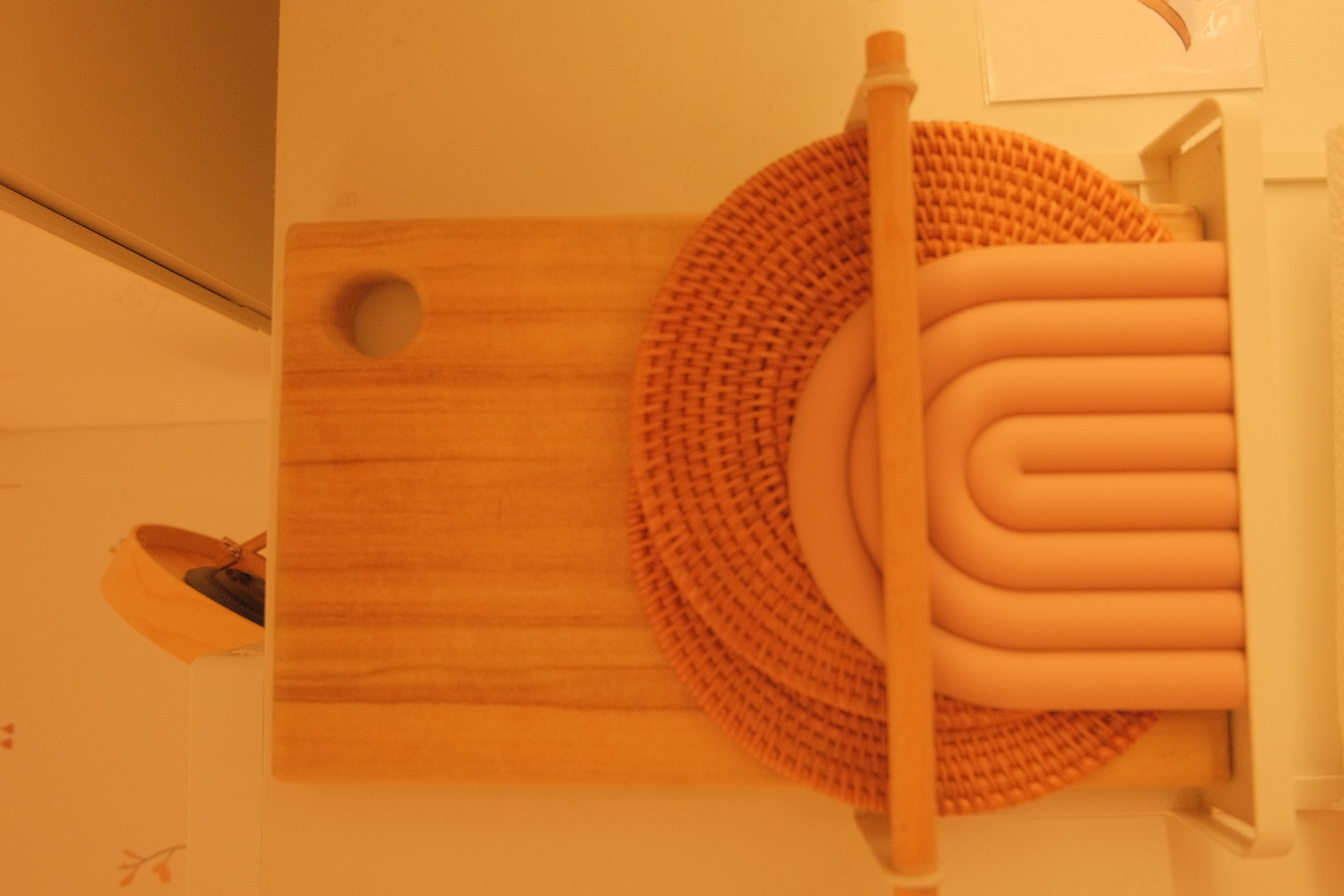 Check out how I Marie Kondo-ed my Kitchen  - Wooden cutting board, woven placemat, orange color, soft surface, minimalist