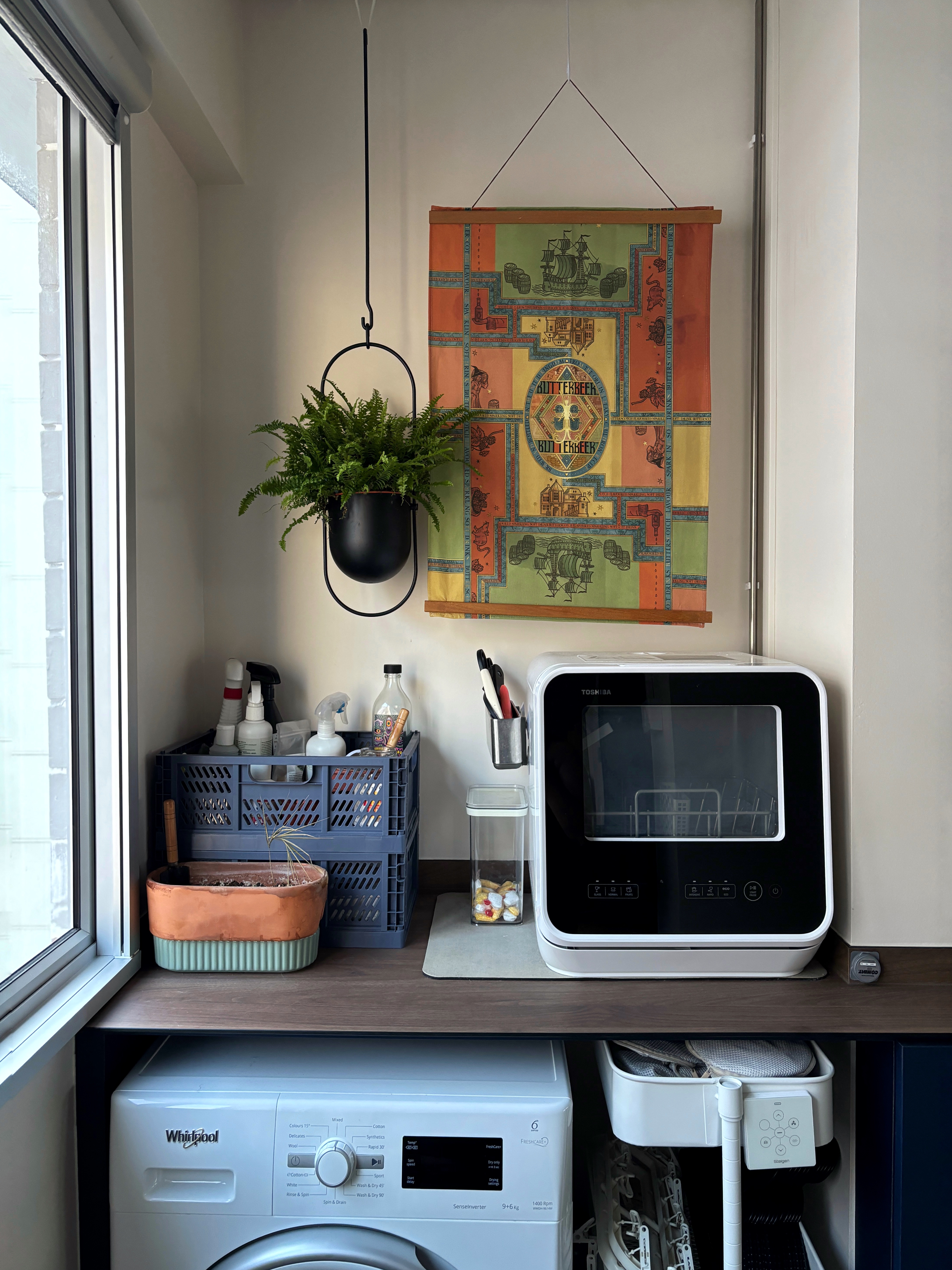 Organising Our Plant Care Corner - Window sill, laundry room, hanging plant, ceramic pot, white washing machine, wooden