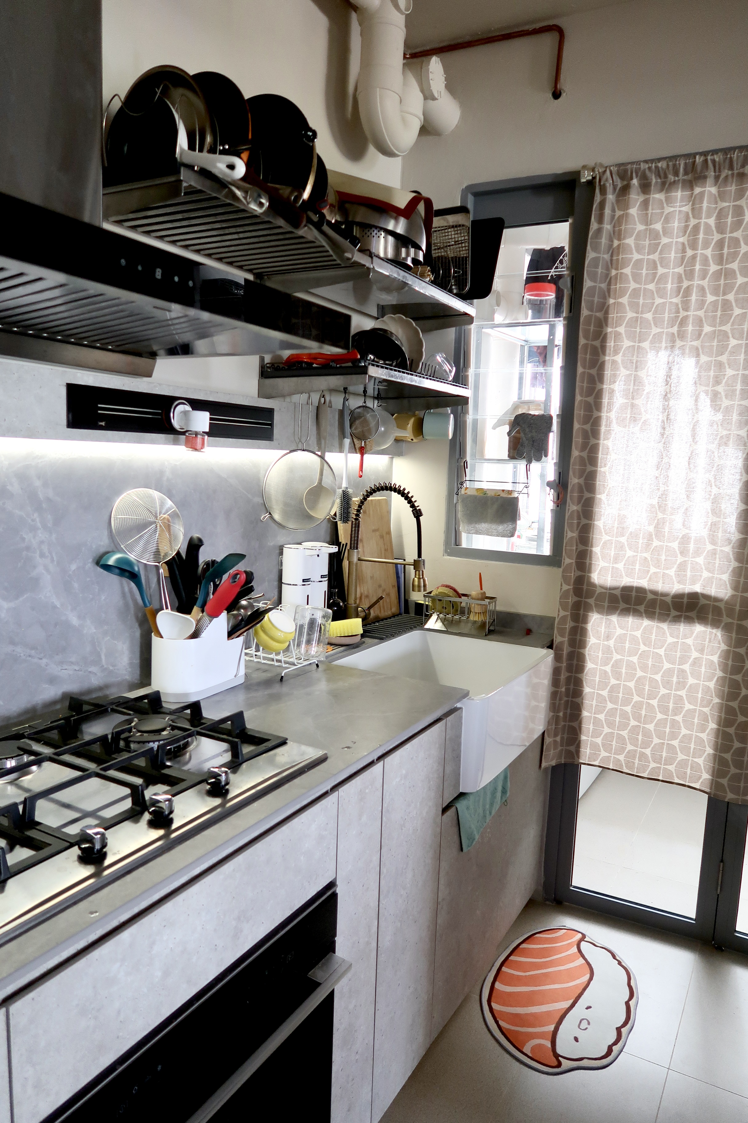 Affordable Ways We Organise Our Minimal Kitchen - Modern kitchen with stainless steel appliances, gas stove, and black range