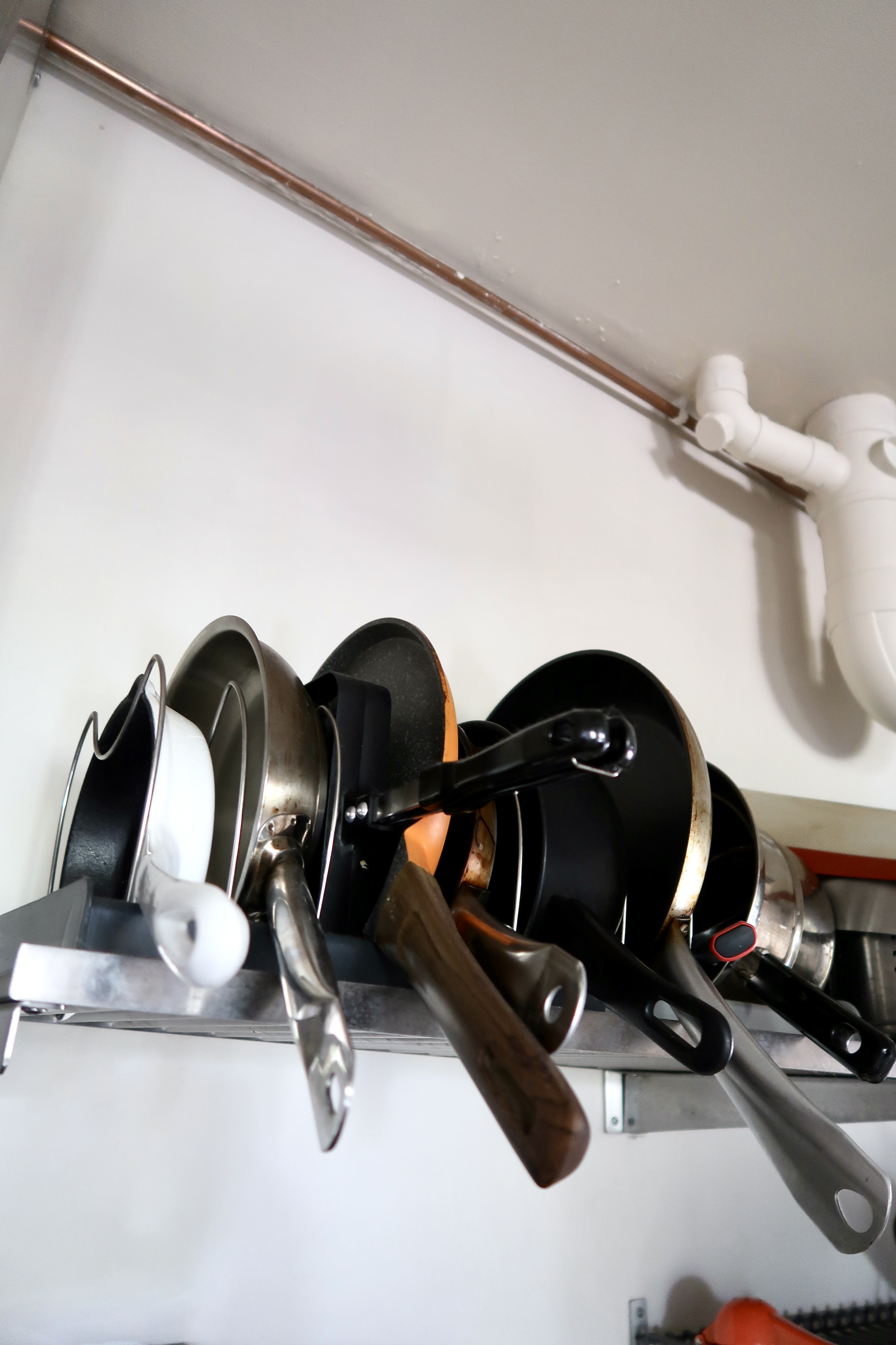 Affordable Ways We Organise Our Minimal Kitchen - stainless steel kitchen utensils, hanging utensils, black and silver pots