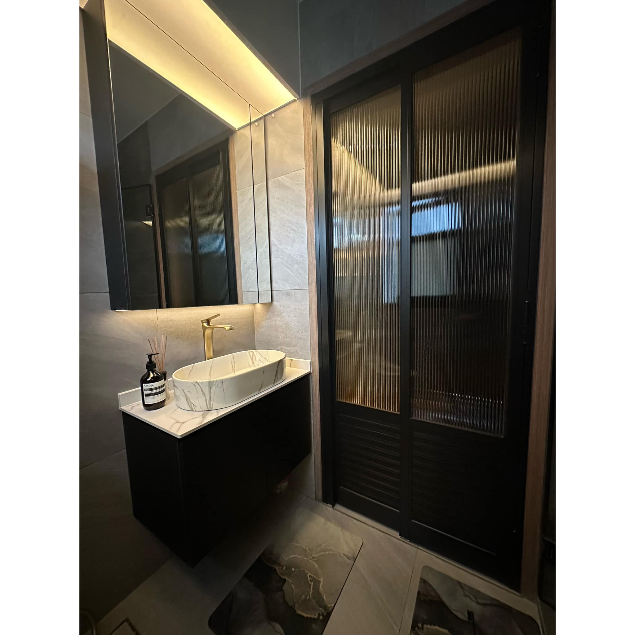 7 Things We Did Right In Our Modern-Lux Bathroom   - Modern bathroom vanity, sleek sink, marble countertop, gold faucet