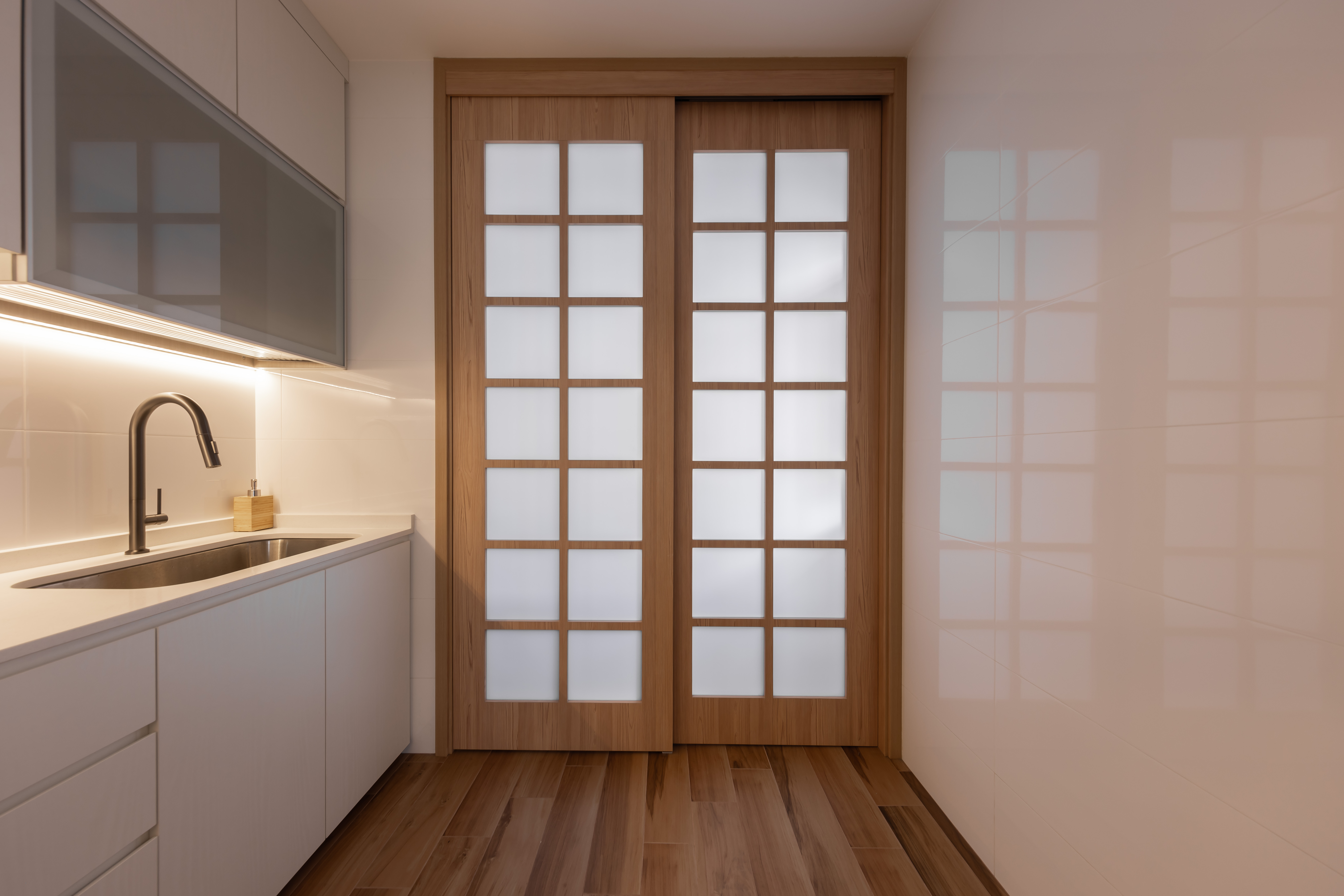 Creating Cozy Spaces: The Magic of LED Strip Lights - Modern kitchen with stainless steel sink, white cabinets, wooden double
