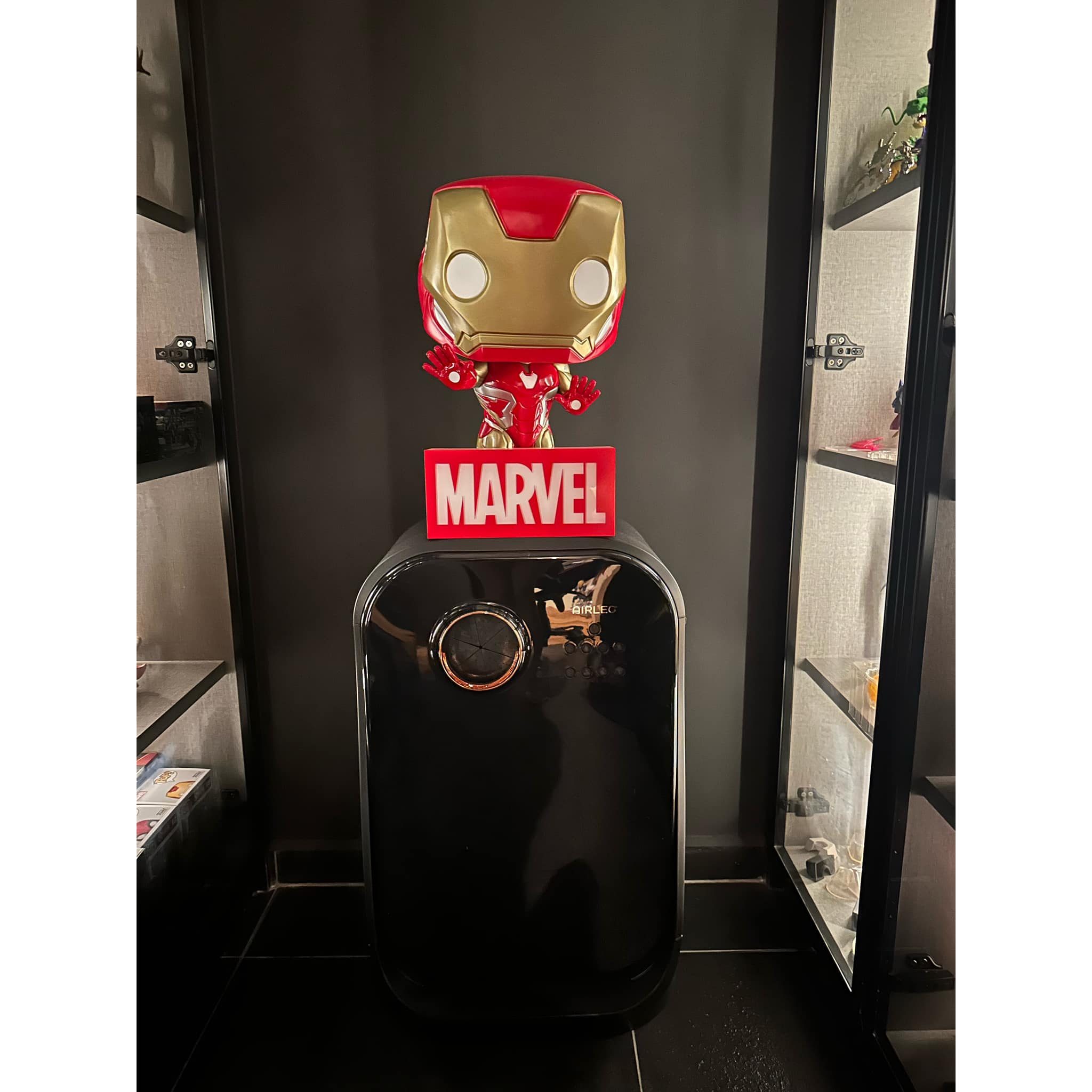 The Work-Play Balance: An Anime & Marvel Collector's Dream Workplace  - Iron Man figurine, Marvel logo, black refrigerator