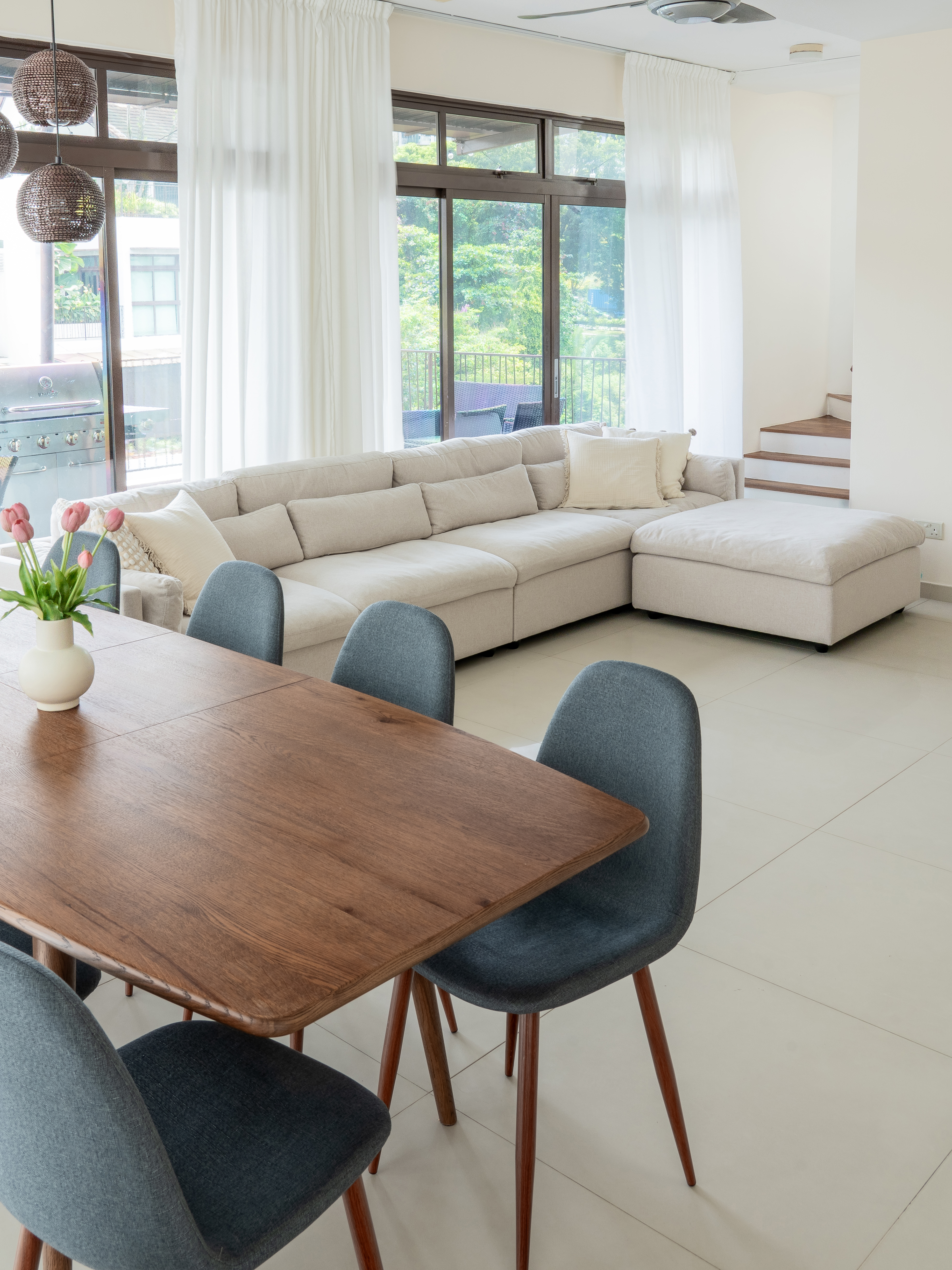 Bright and airy living room: The heart of our home - Modern living room with large windows, beige sectional sofa, wooden