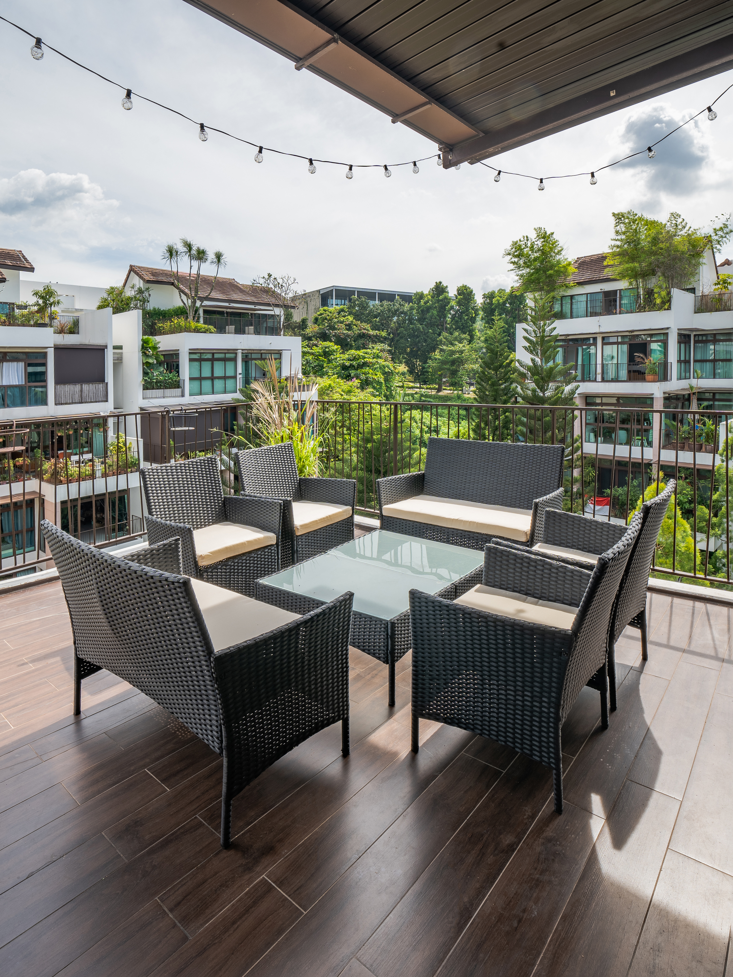 Our favourite spot to chill and barbecue in our outdoor balcony - Modern outdoor patio with wicker furniture, dark wooden