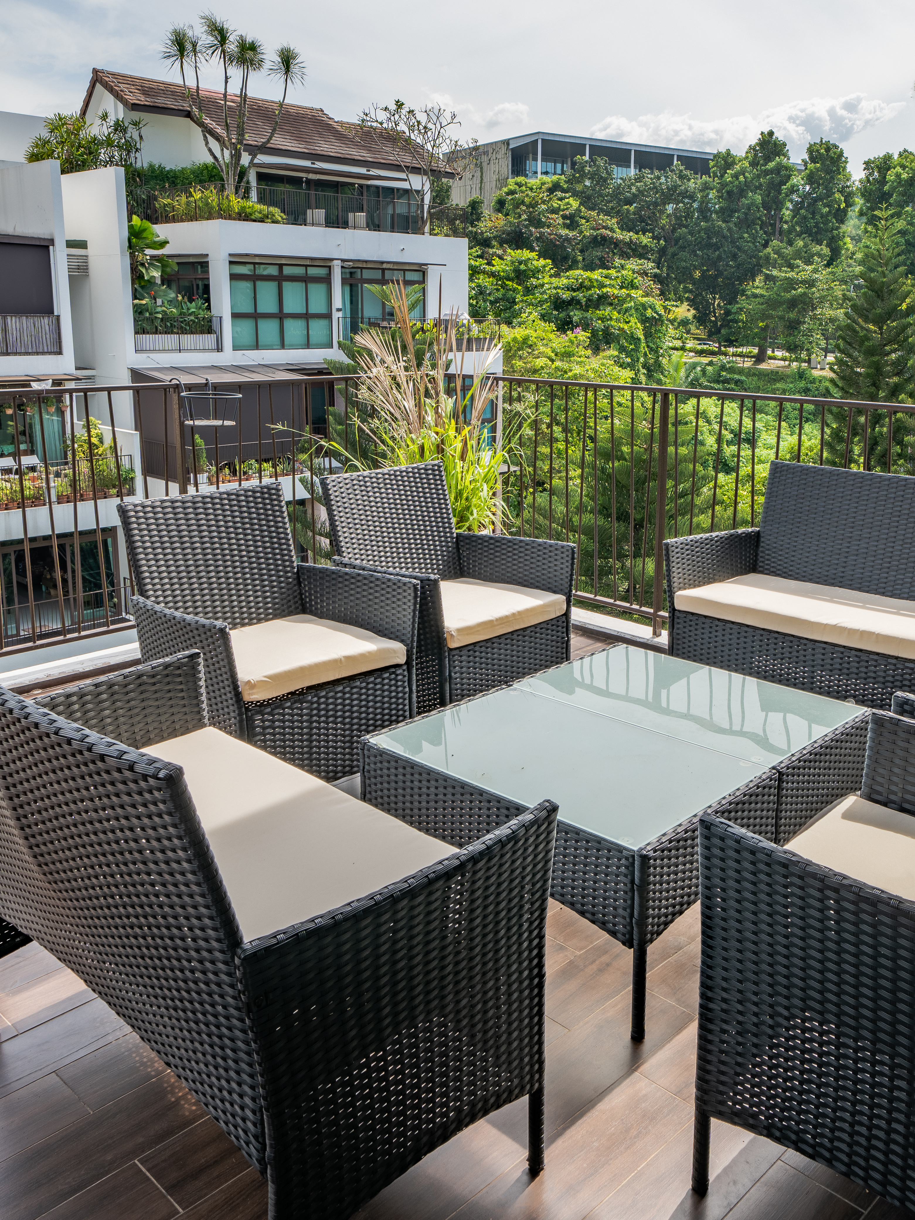 Our favourite spot to chill and barbecue in our outdoor balcony - Modern outdoor patio with wicker furniture, glass-top