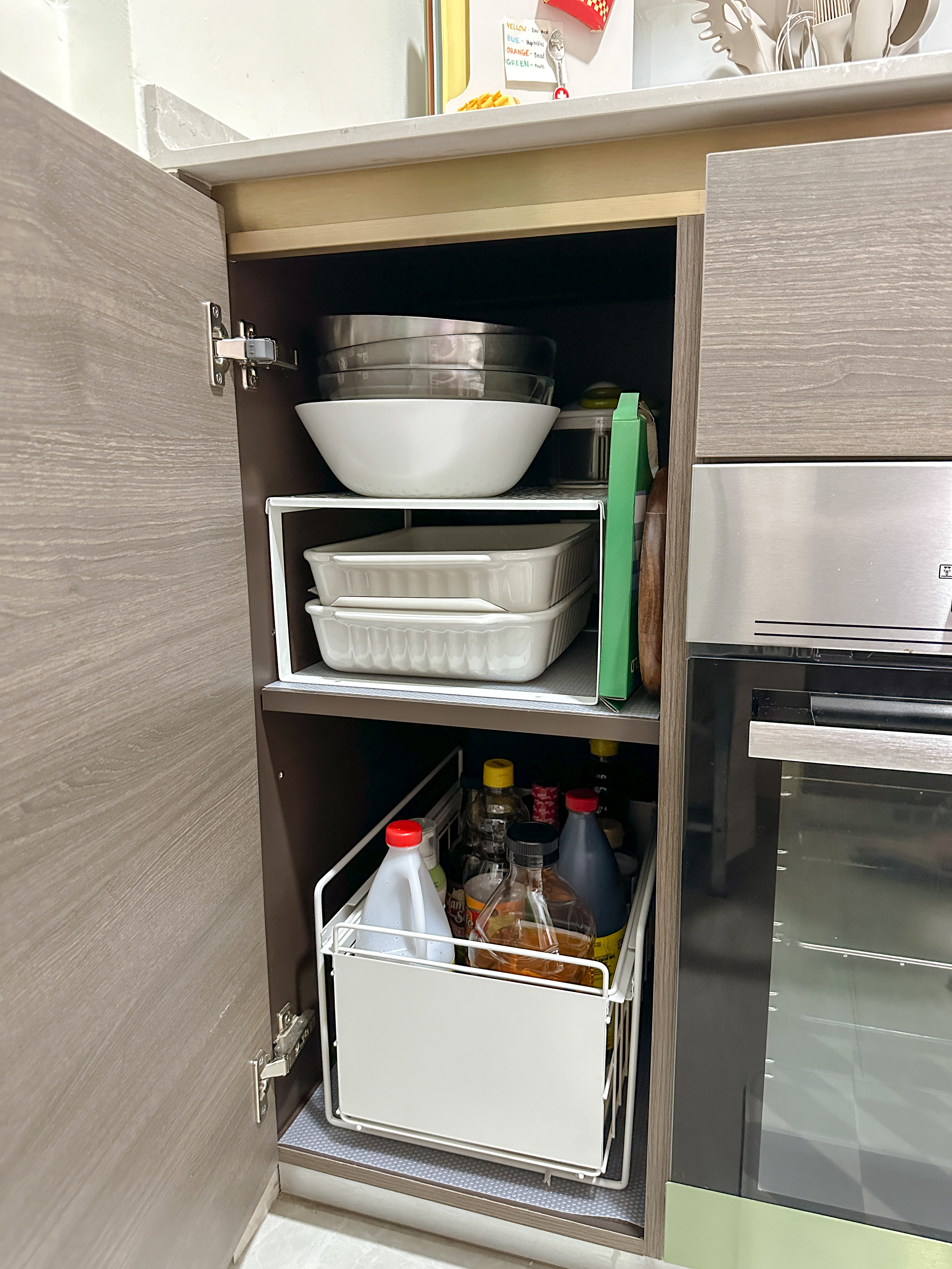 A little tour of our kitchen organizers! ✨ - Kitchen cabinet, open shelf, white bowls, metal tray, plastic trays, green box