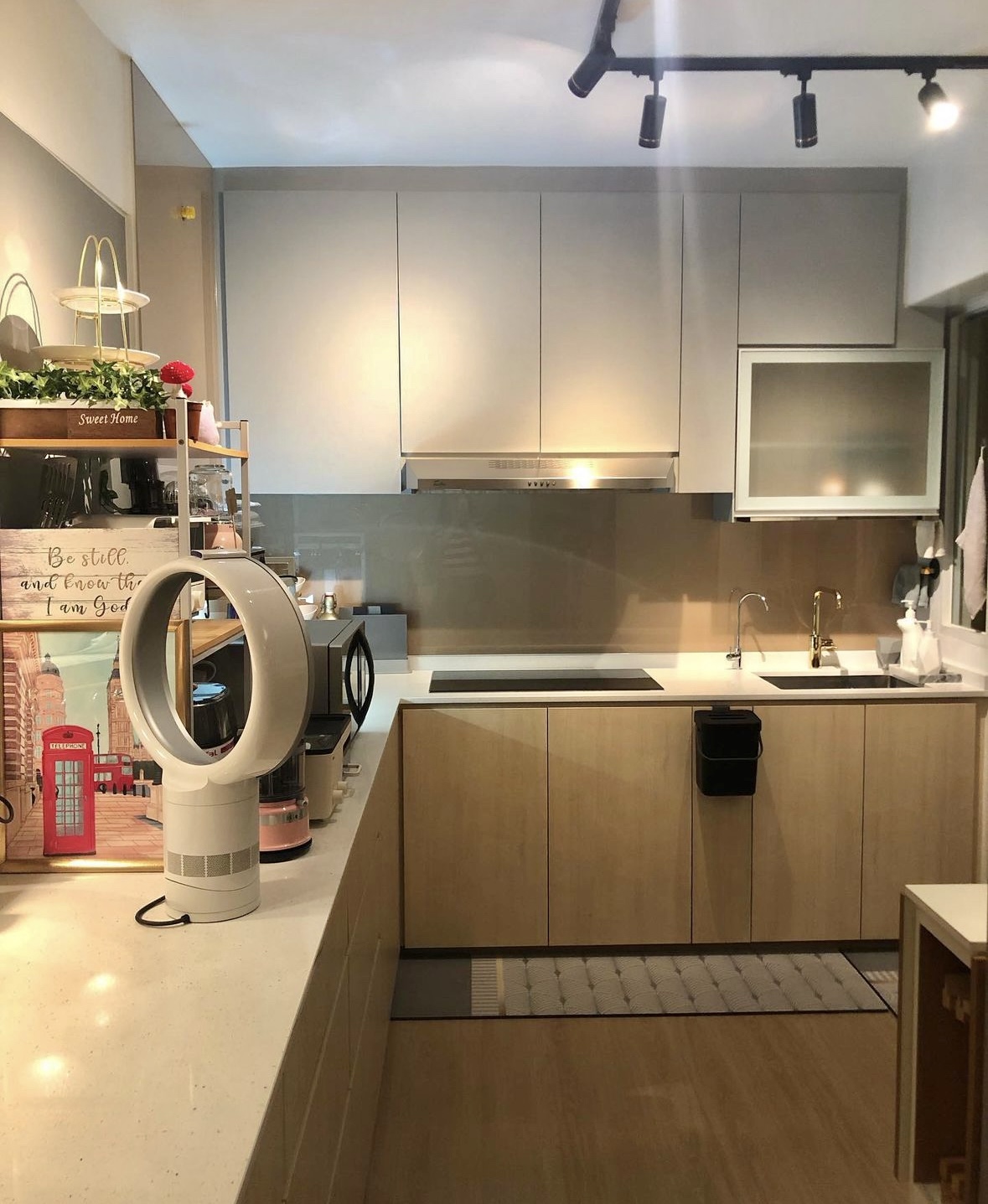 3 Non-Essentials Reno Costs We Saved On - Modern kitchen with sleek cabinetry, stainless steel range hood, white countertops