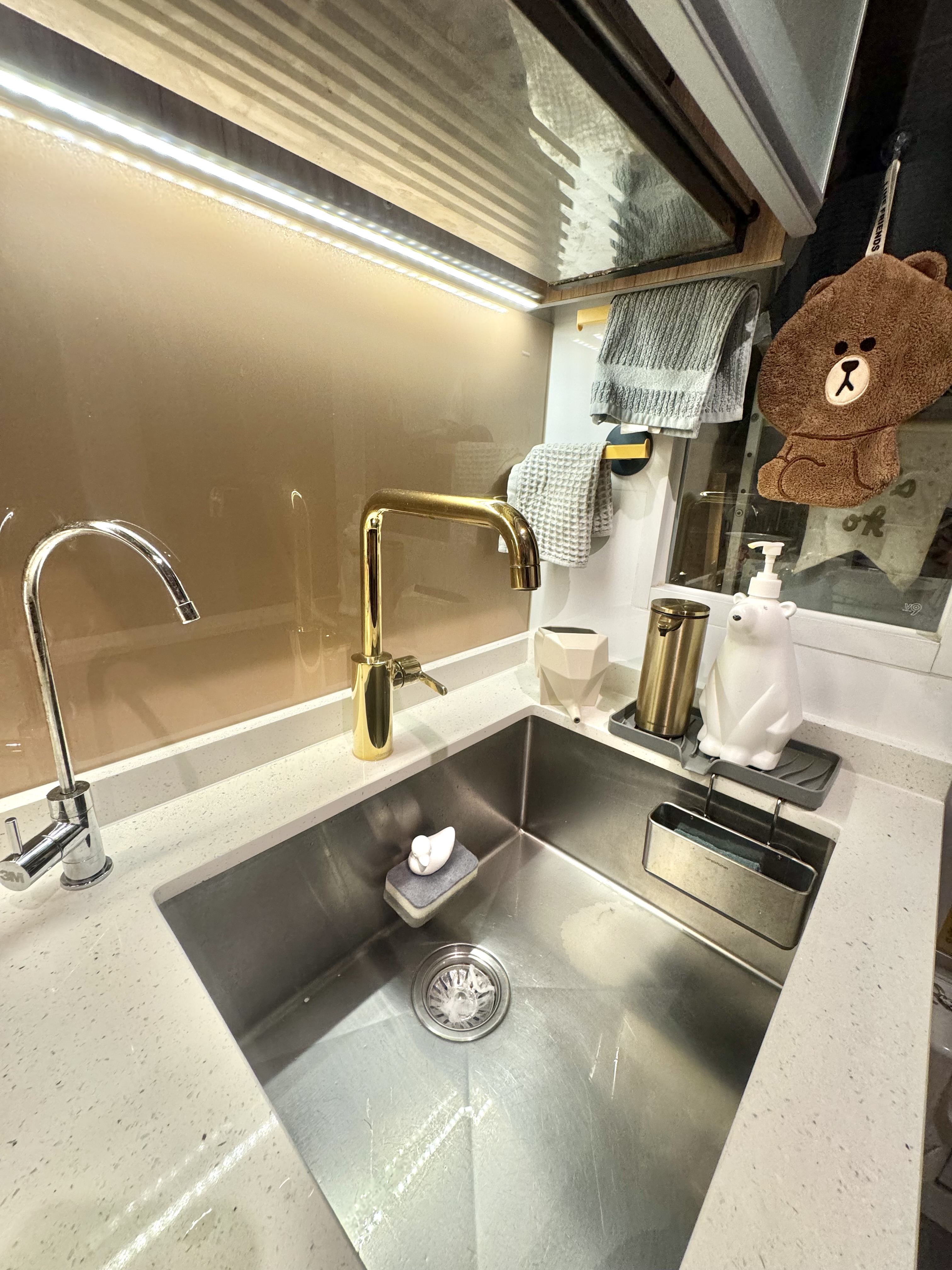 3 Non-Essentials Reno Costs We Saved On - Modern kitchen sink, sleek faucet, gold finish, stainless steel sink, under-mount