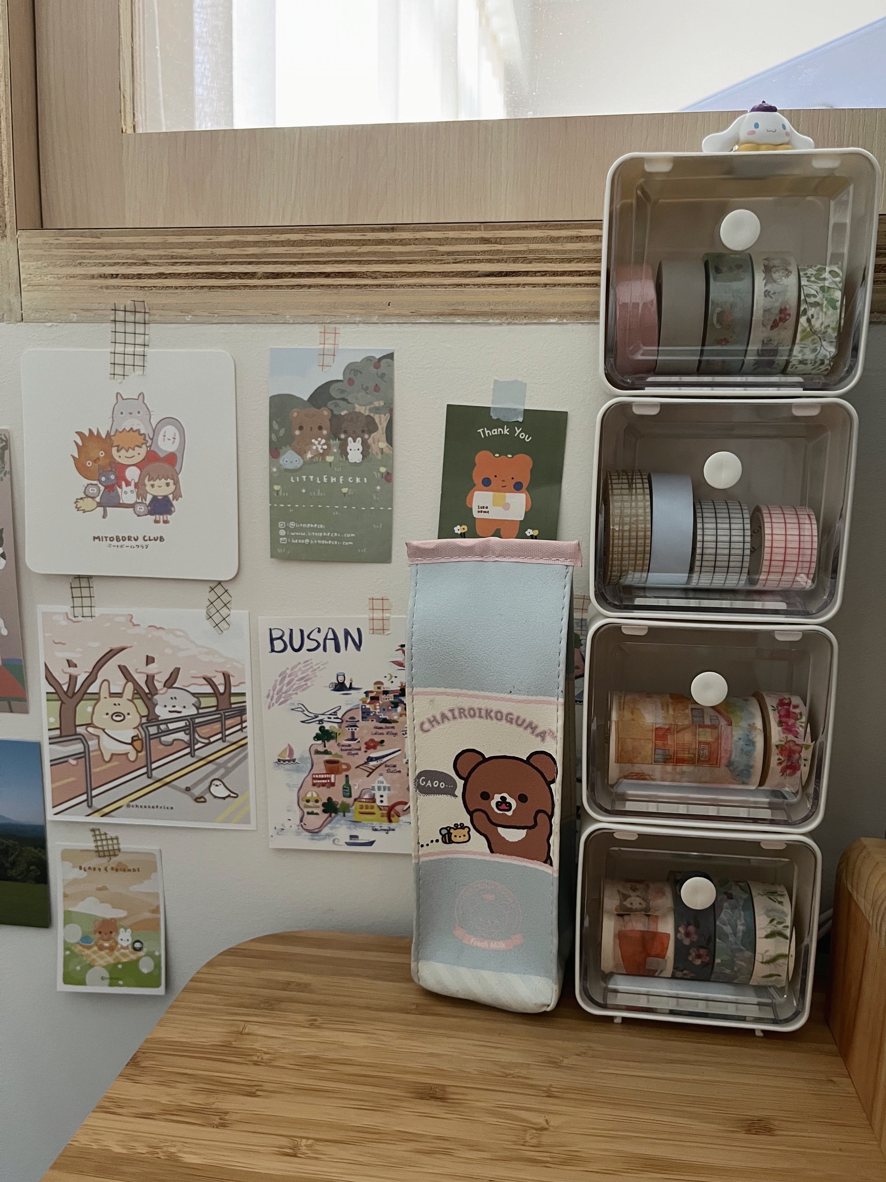 How I organise my desk  - Wooden wall adorned with cute stationery items, Clear storage bins filled with colorful tapes, Cute