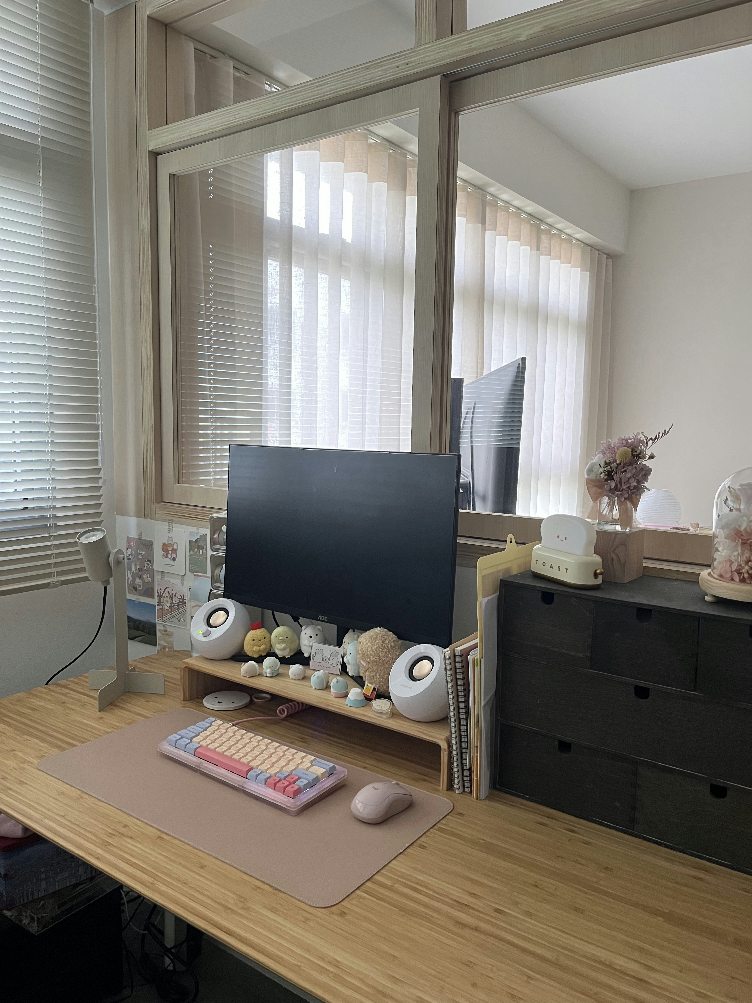 How I organise my desk  - Wooden desk, computer monitor, black screen, white speakers, colorful keyboard, beige mouse pad