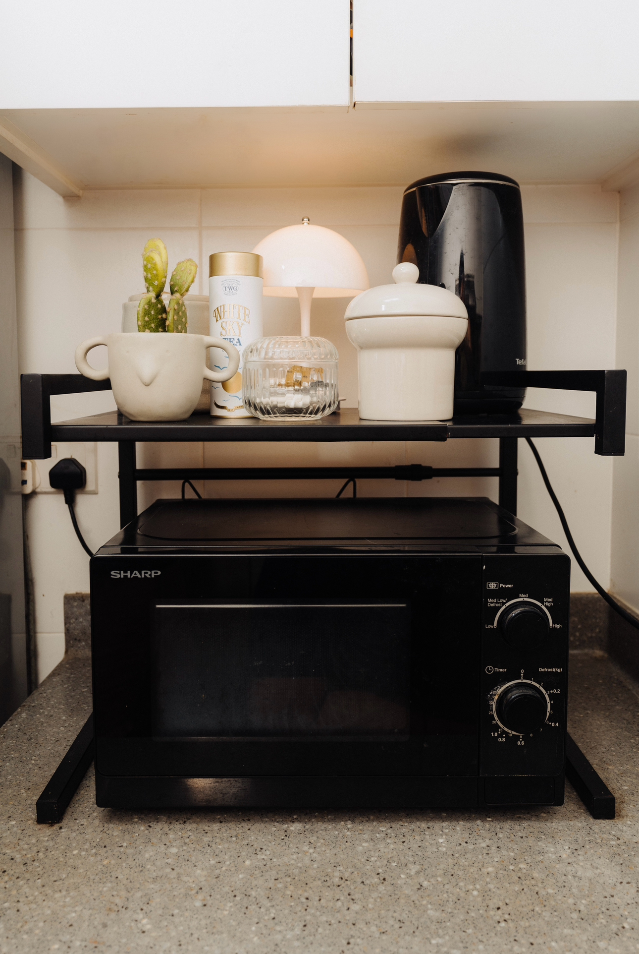 Tiny Kitchen Living: Organisation Tips To Live Mess Free - microwave, black toaster, countertop, kitchen shelf, white cup
