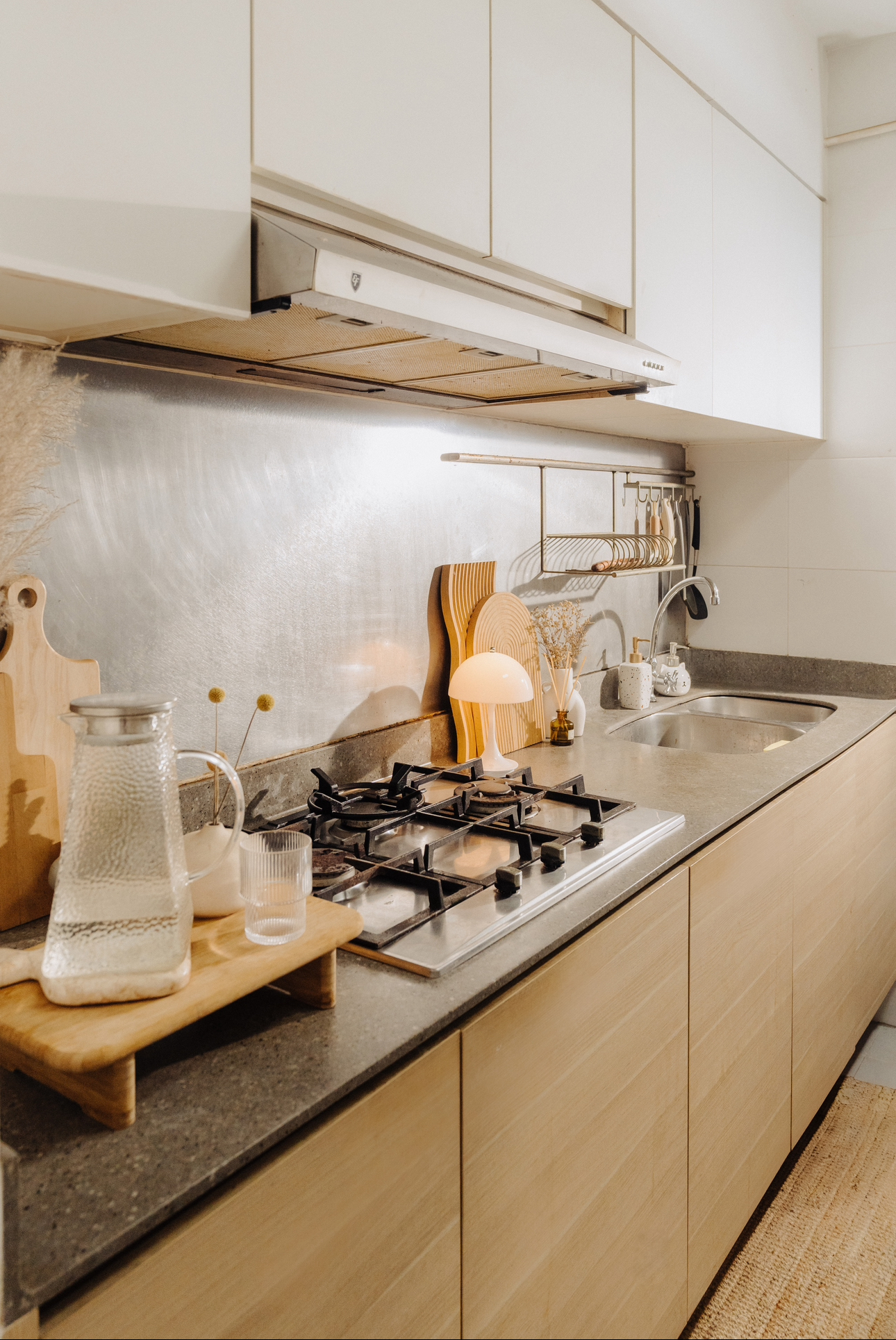 Tiny Kitchen Living: Organisation Tips To Live Mess Free - modern kitchen, stainless steel backsplash, light wood cabinets