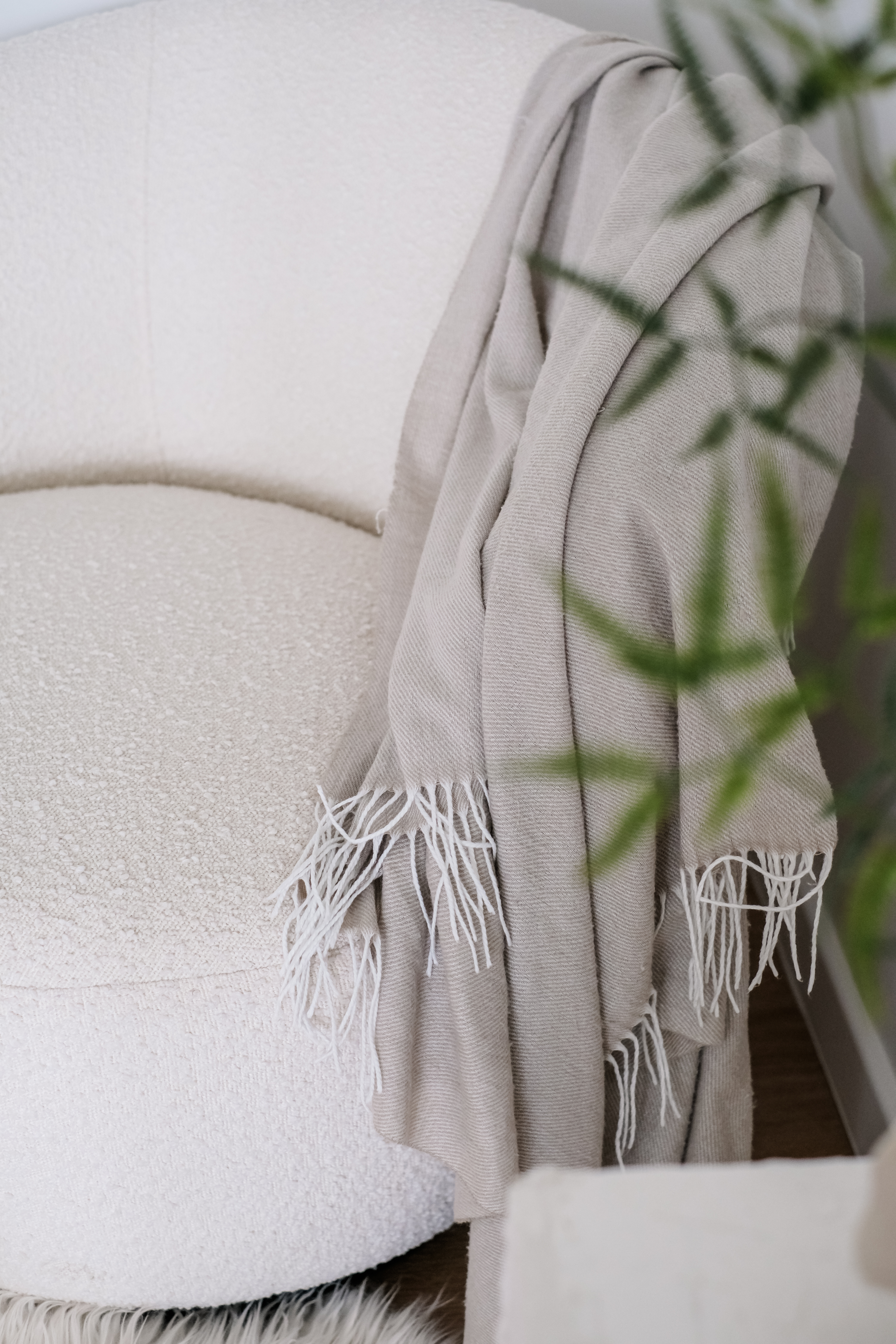 Creating a Cozy Corner: A Personal Retreat for Reading and Reflection - Soft beige shawl with fringed edges draped over a