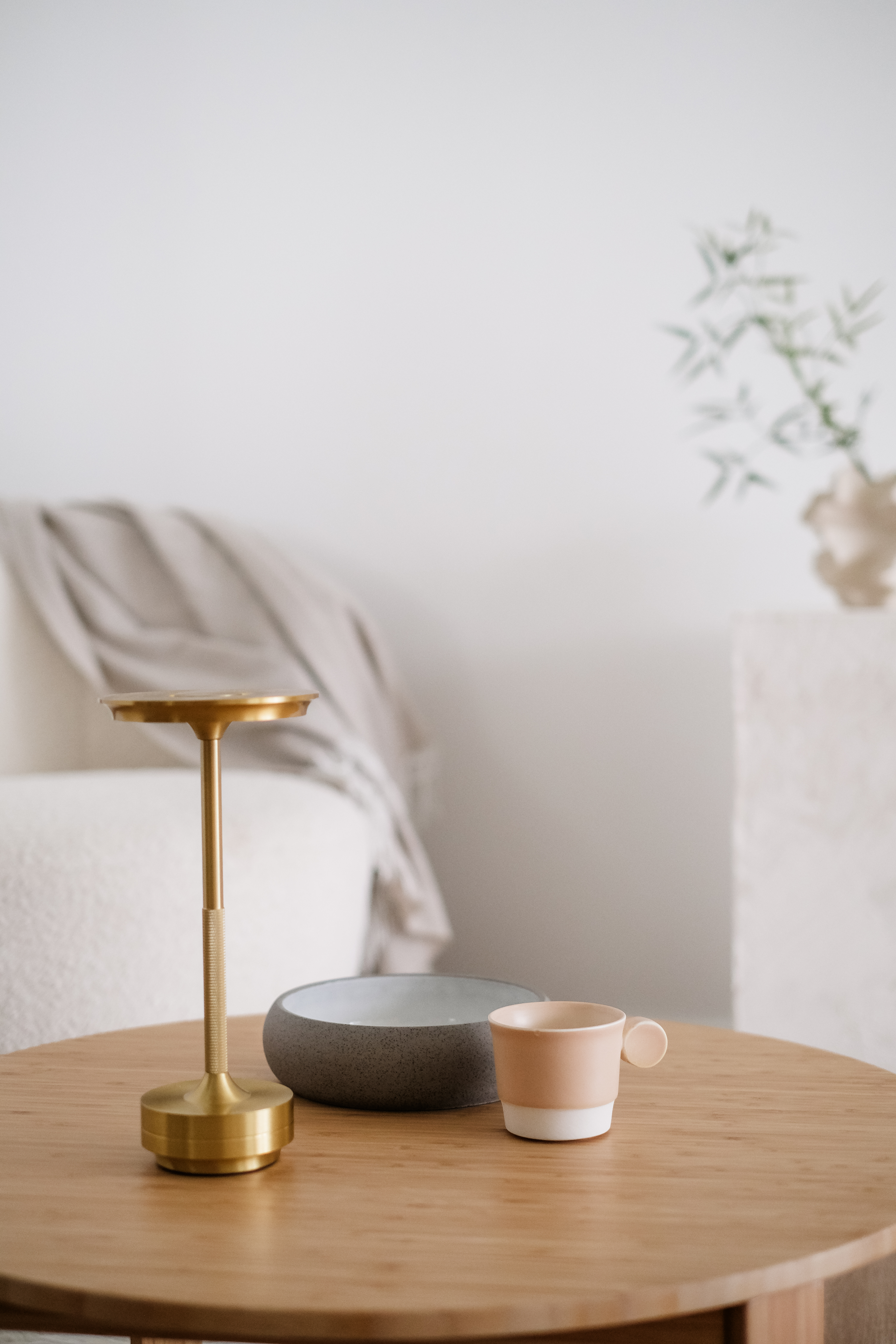 Creating a Cozy Corner: A Personal Retreat for Reading and Reflection - Gold candlestick, wooden table, minimalist decor