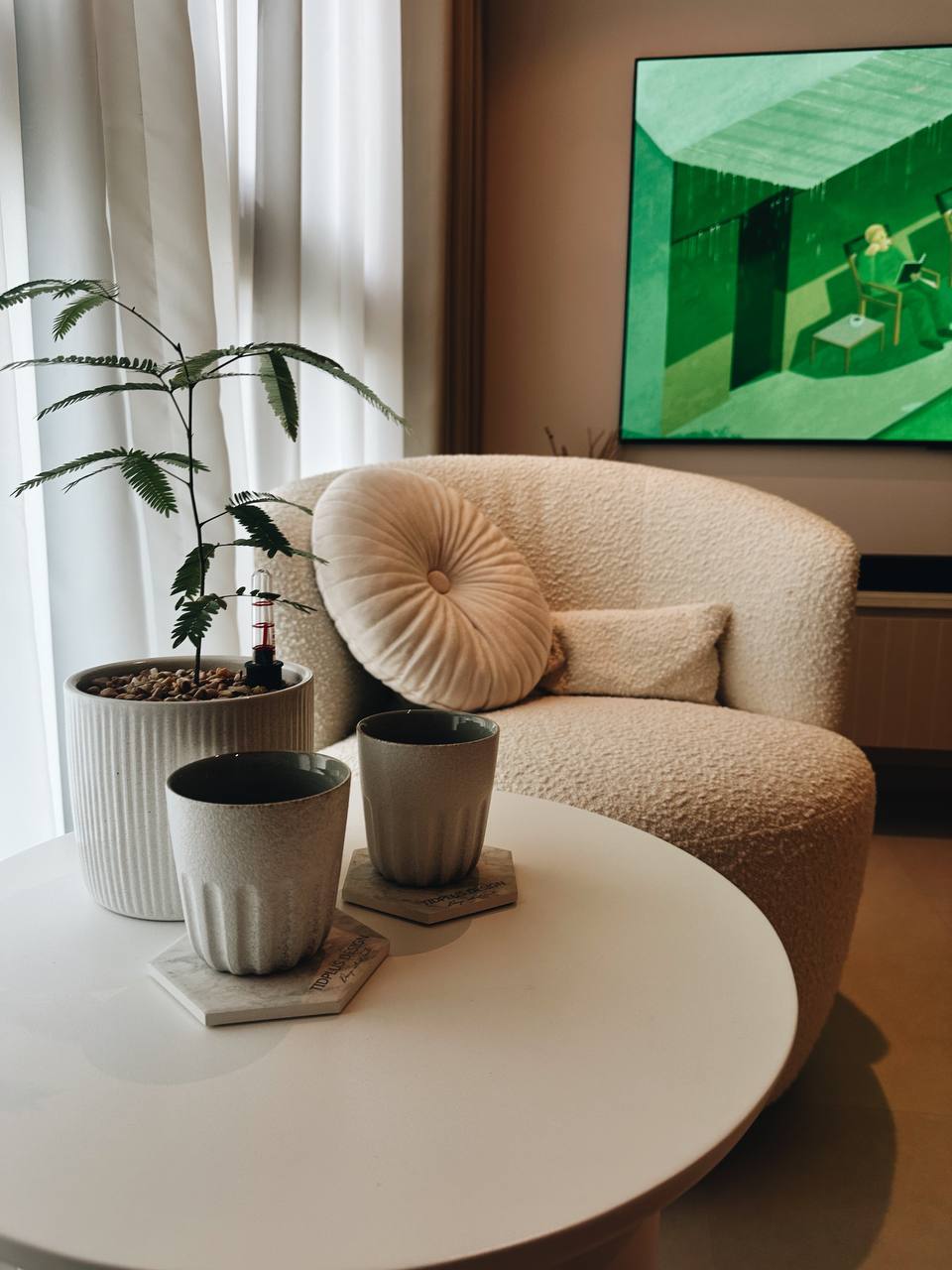 Our Cozy Lounge Corner: Arch Frame for our plant babies - Cream-colored plush armchair, modern minimalist decor, indoor