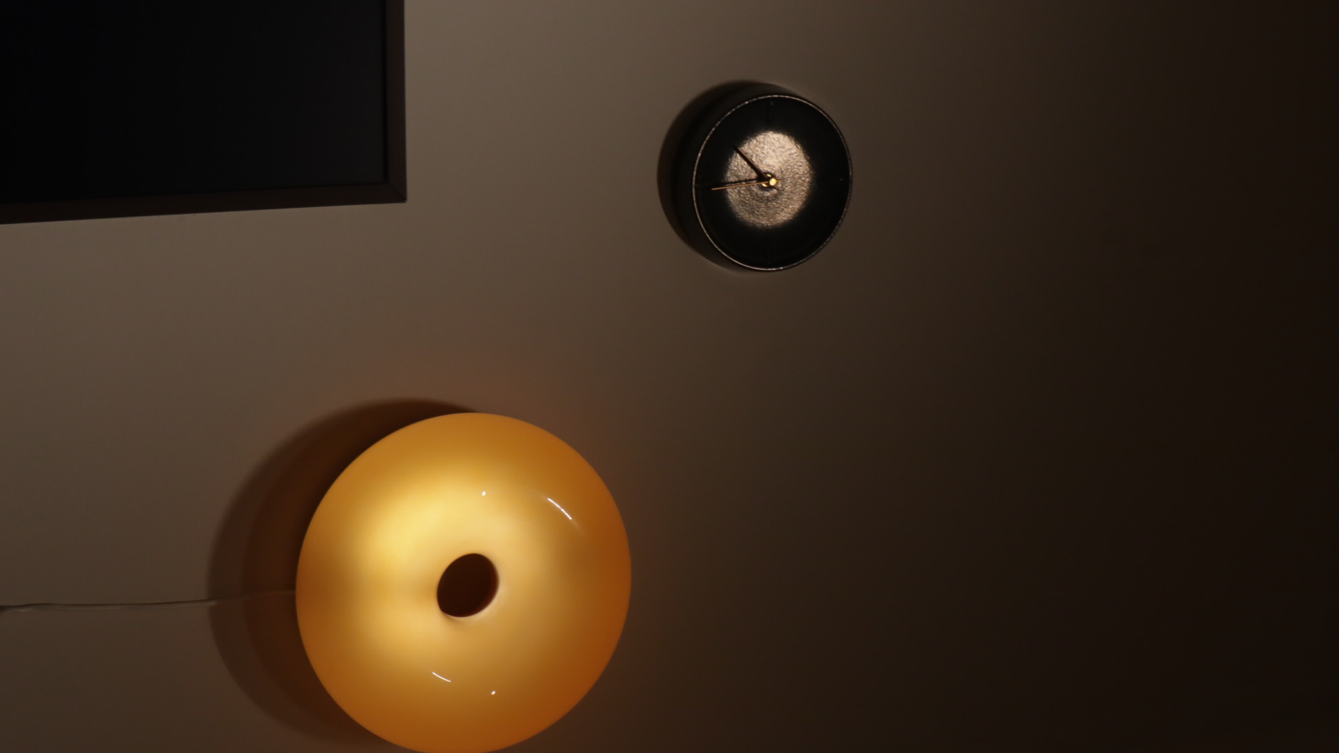 (chair, book, light) maketh nook : trinity to a cosy corner  - Modern minimalist wall, abstract light fixture, glowing orange