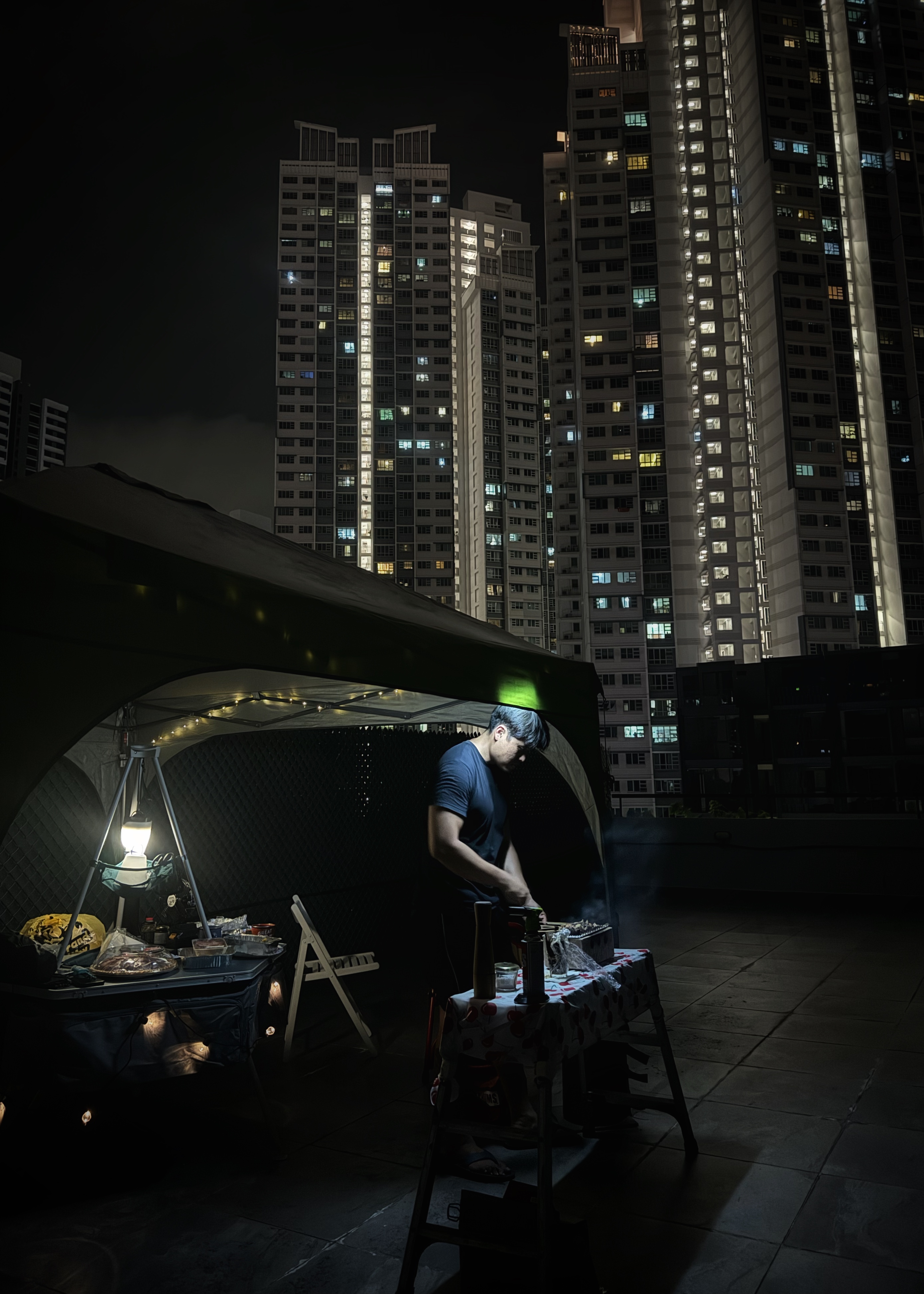 The roof is on FIRE!! 🔥🔥🔥 - tents, night, cityscape, urban environment, tall buildings, illuminated windows, artificial