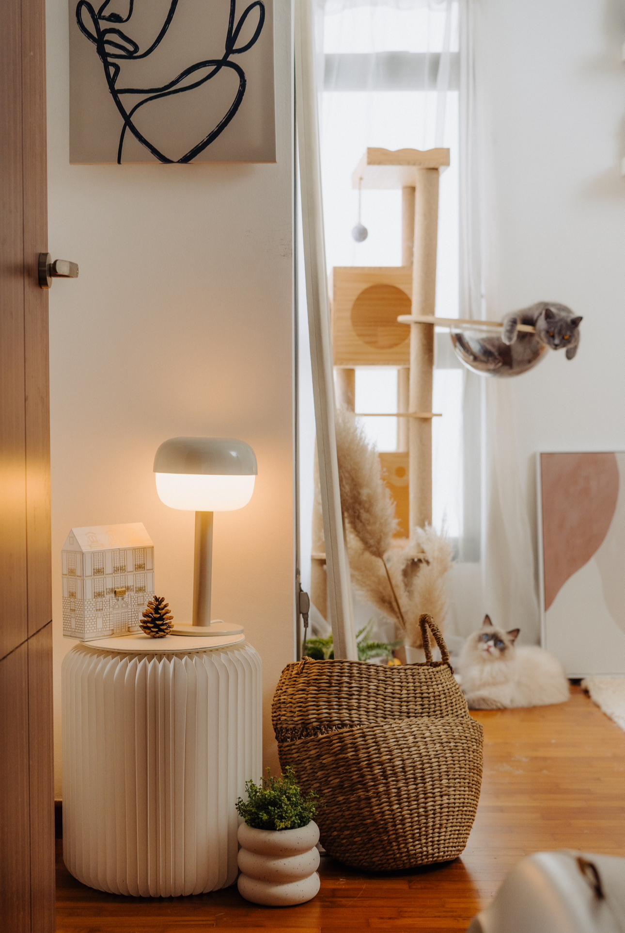 Our Spare Room: Styling It Into A Cosy & Multifunctional Space - White cylindrical side table, modern lamp, cozy room, wooden