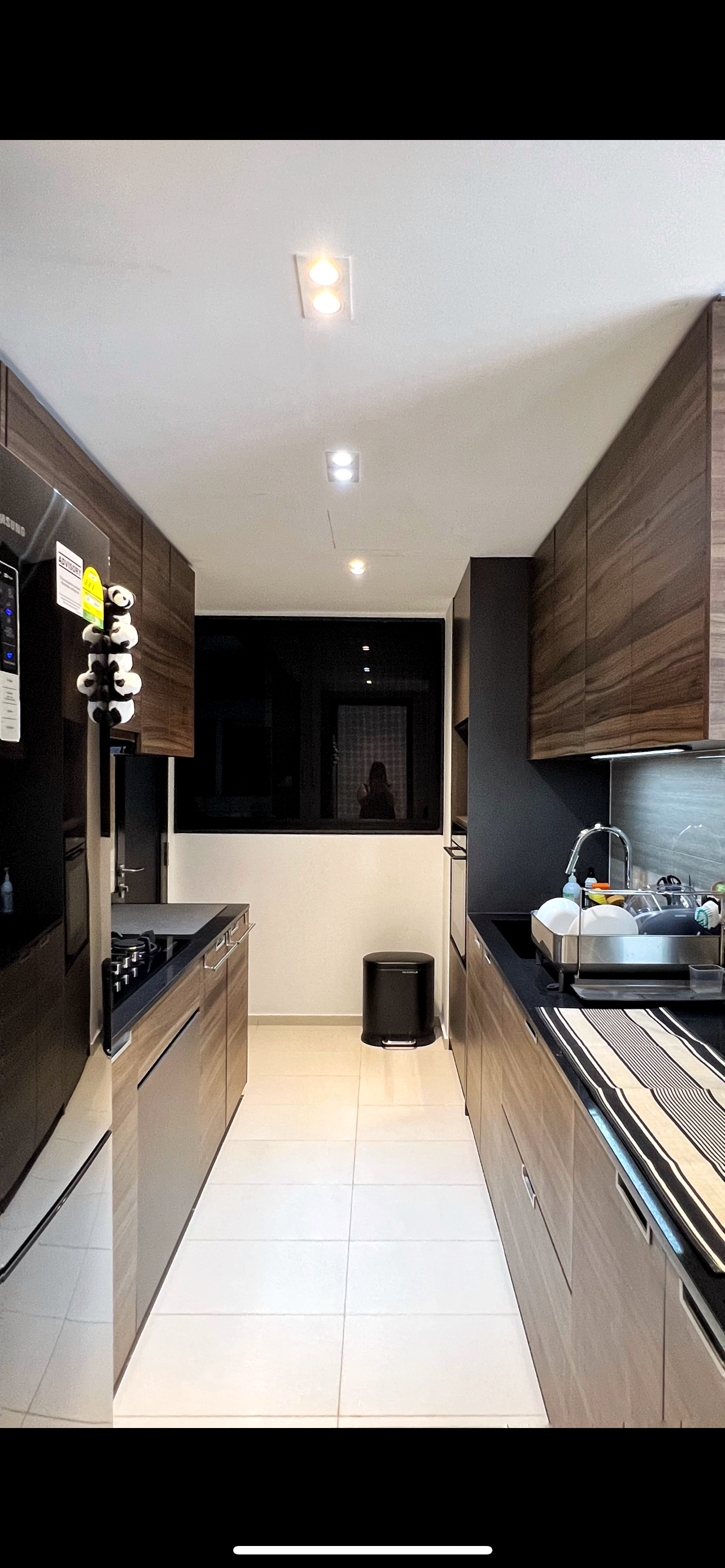 From Clutter to Calm: Transforming with Thoughtful Organization - Modern kitchen with sleek design, dark wood cabinets