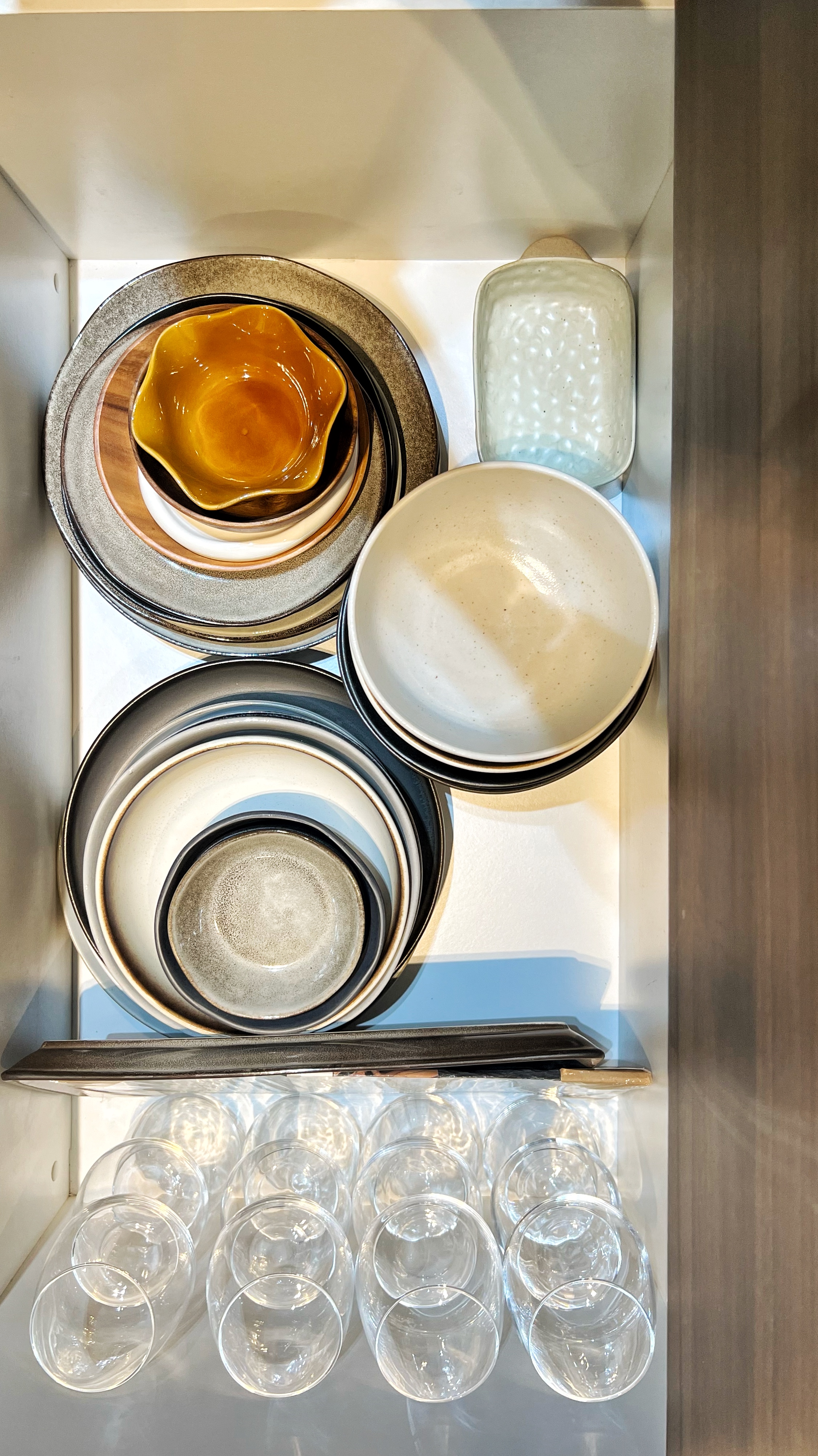 From Clutter to Calm: Transforming with Thoughtful Organization - Dining table, kitchenware, plates, bowls, glassware