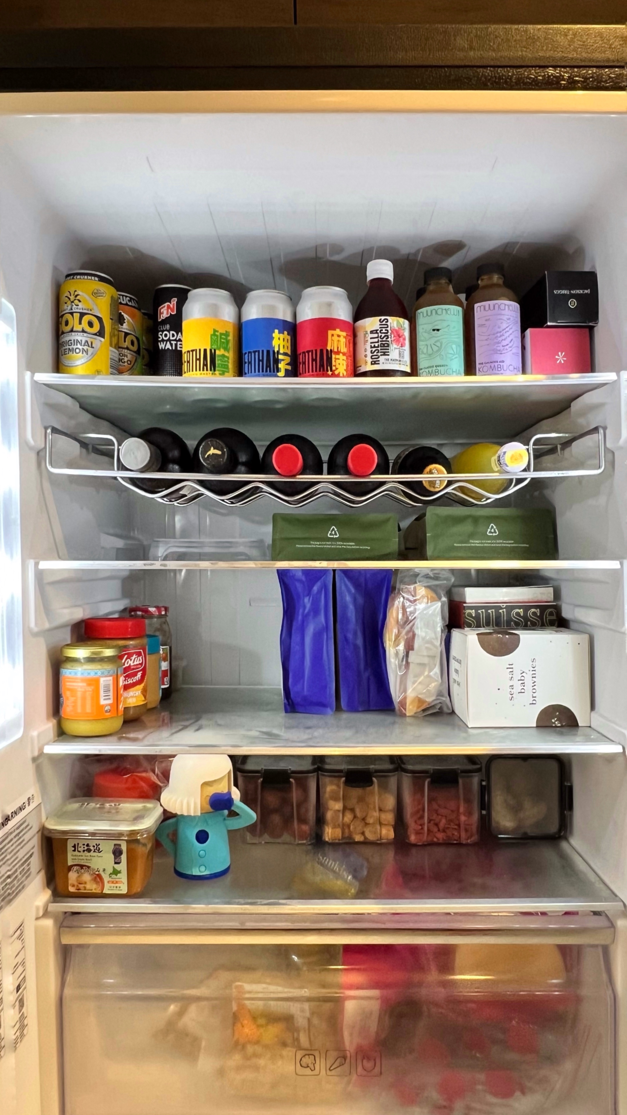 From Clutter to Calm: Transforming with Thoughtful Organization - Various beverages including soda cans and bottled drinks on