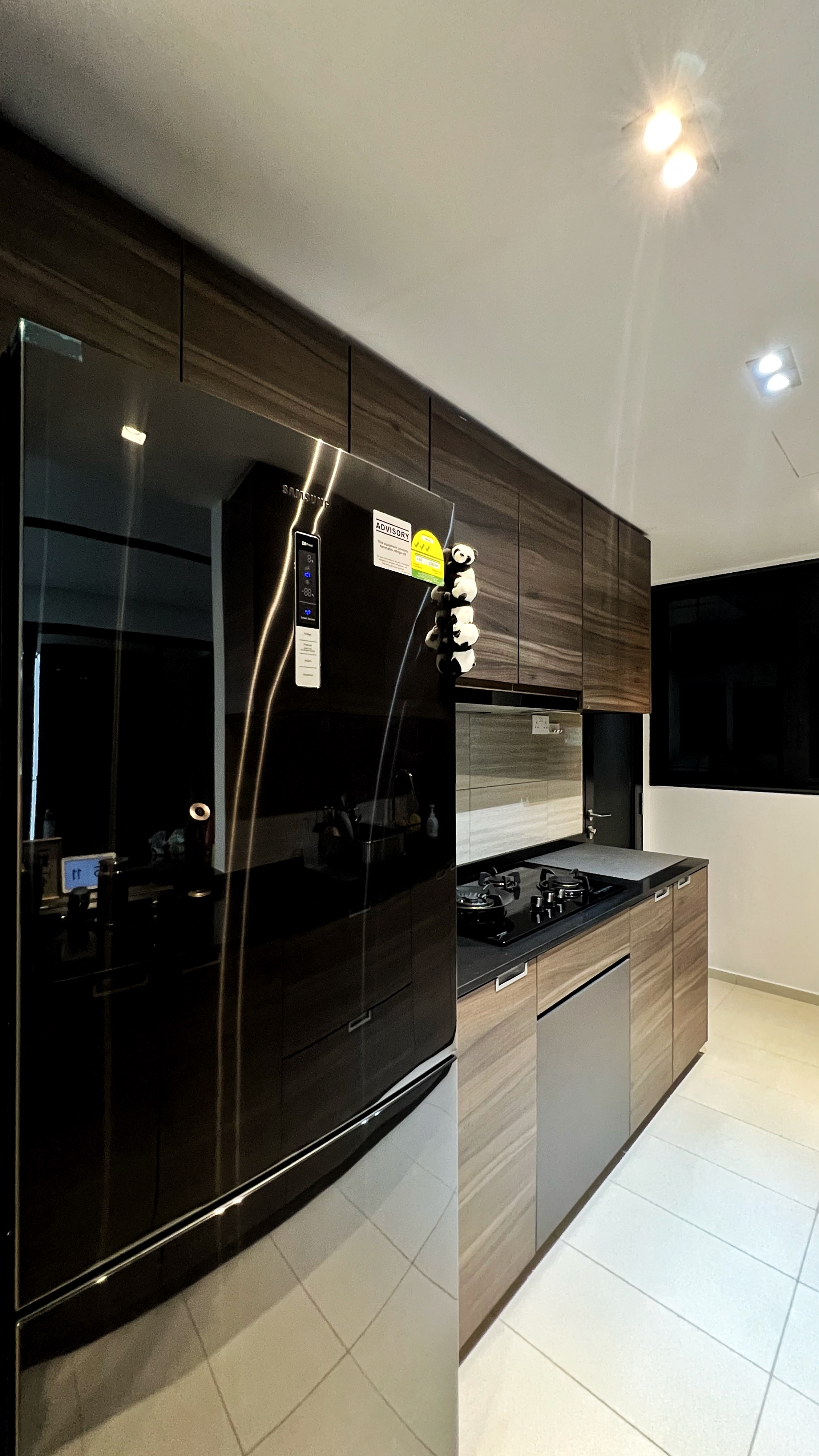 From Clutter to Calm: Transforming with Thoughtful Organization - Dark kitchen cabinetry, sleek appliances, modern design