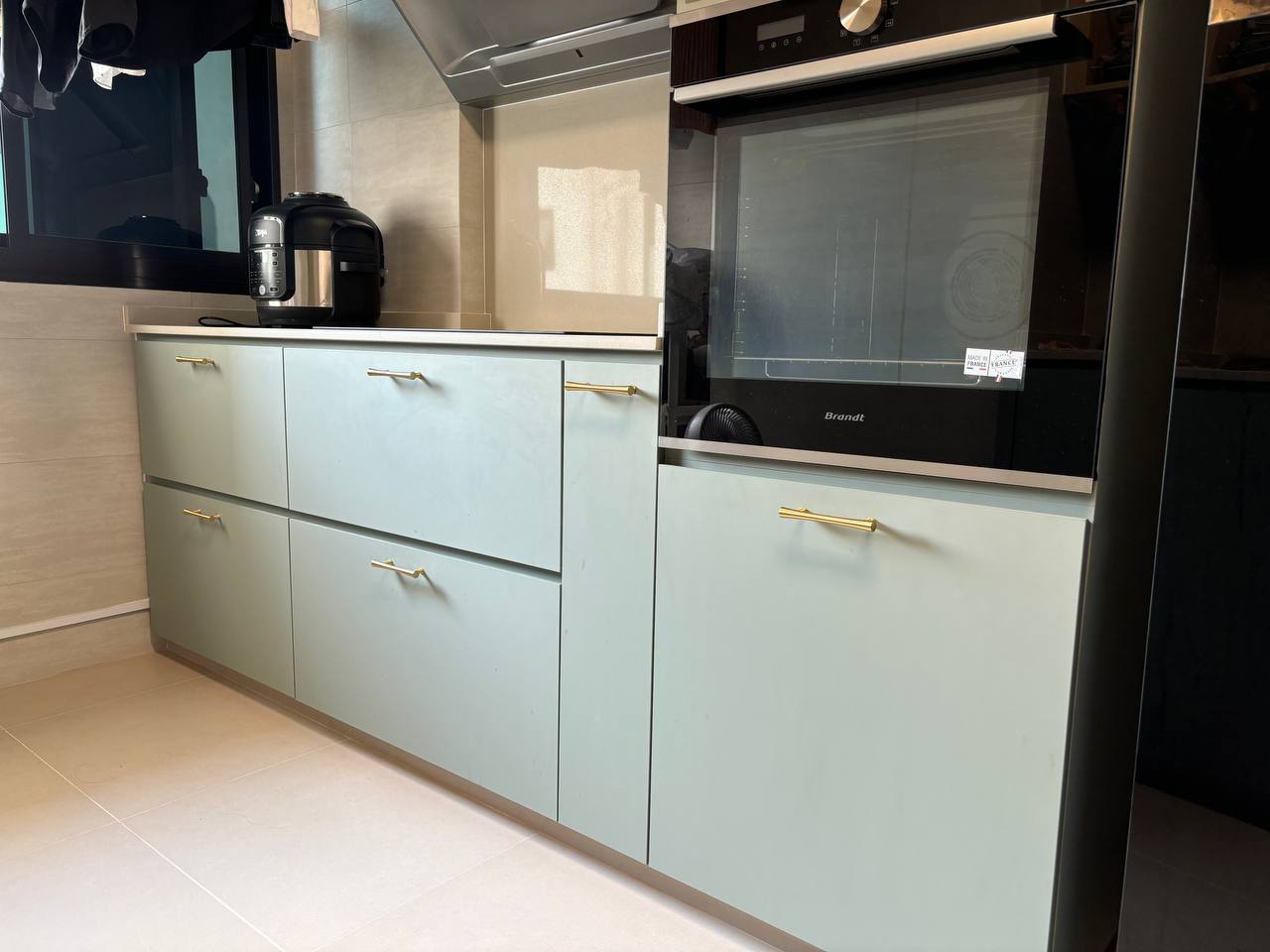 Utilising deep drawers & tower cabinet for Kitchen organisation - Light green kitchen cabinets with gold handles, black