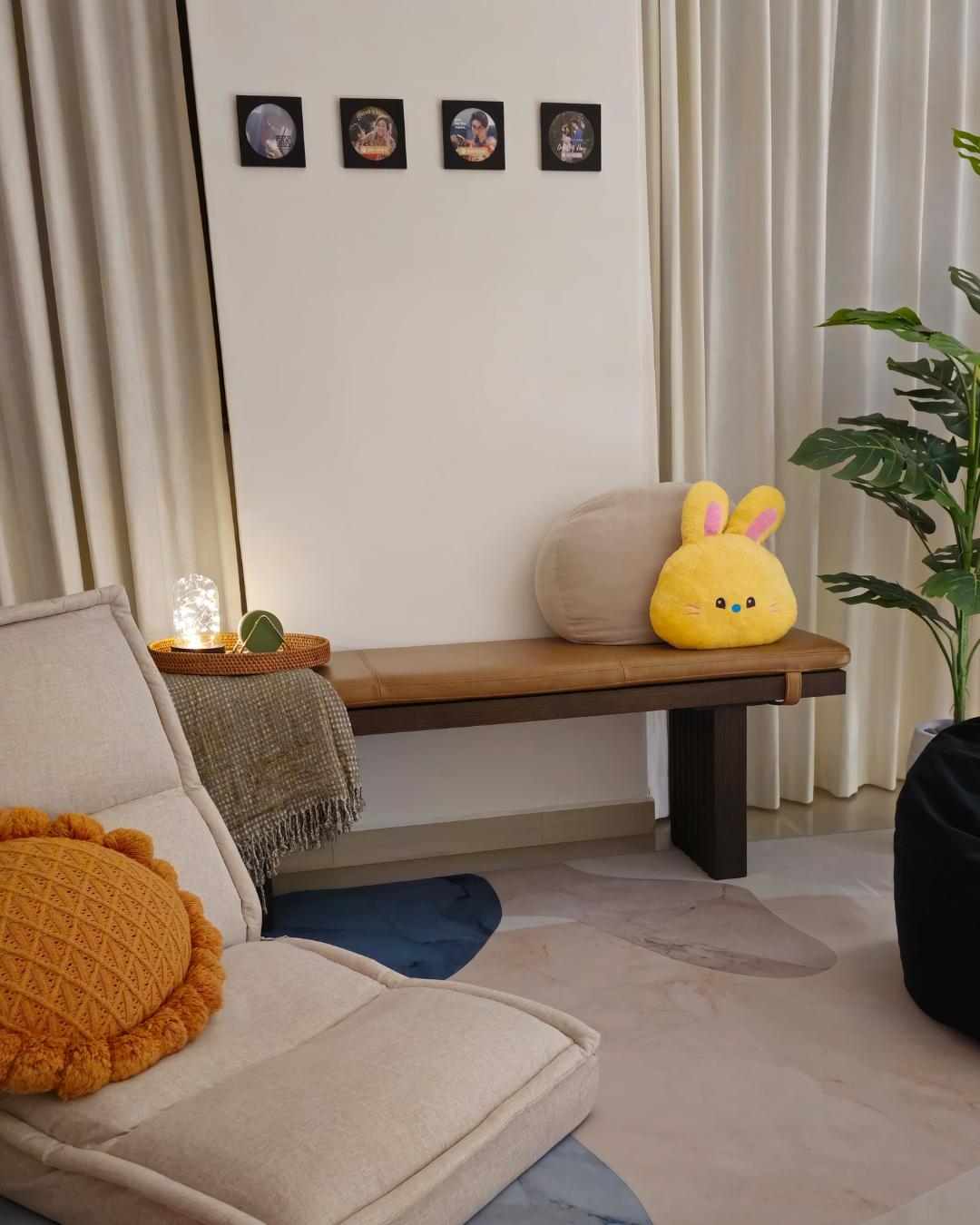 Hosting at Home: From 2 to 22  - Creamy beige sofa, plush yellow bunny pillow, textured beige fabric, cozy armchair, modern